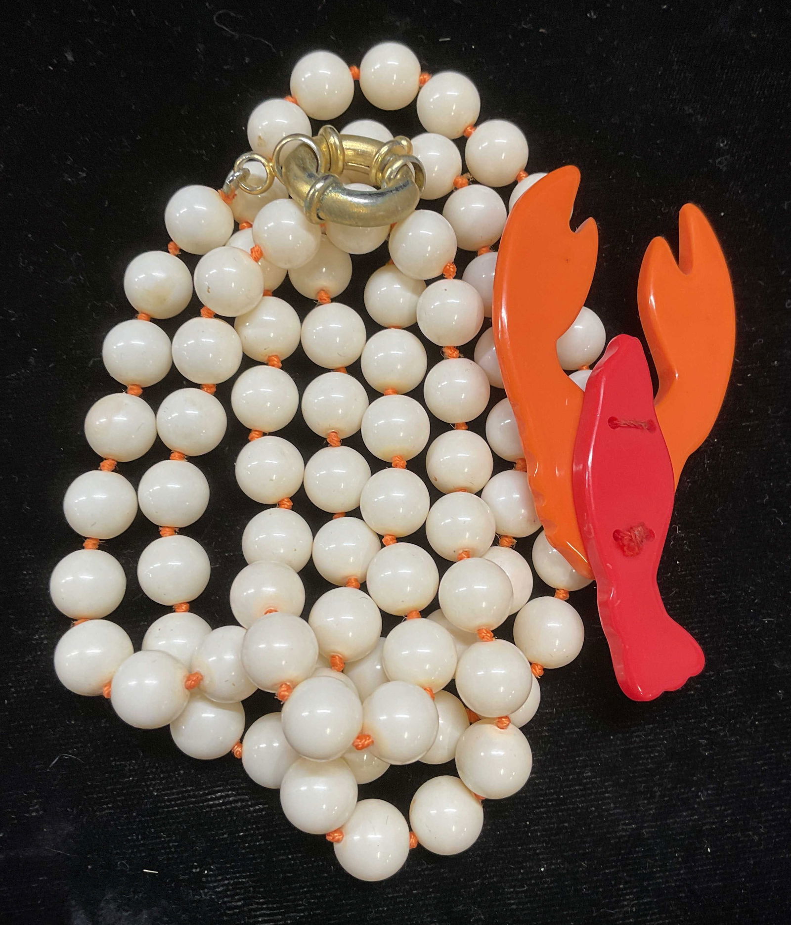 Vintage White Beaded Lobster Necklace: Vintage white beaded necklace with red and orange lucite lobster pendant. Drop length approx 17.5 inches. Some scratching. Jewelry, estate jewelry, costume jewelry, cocktail jewelry, fashion jewelry,