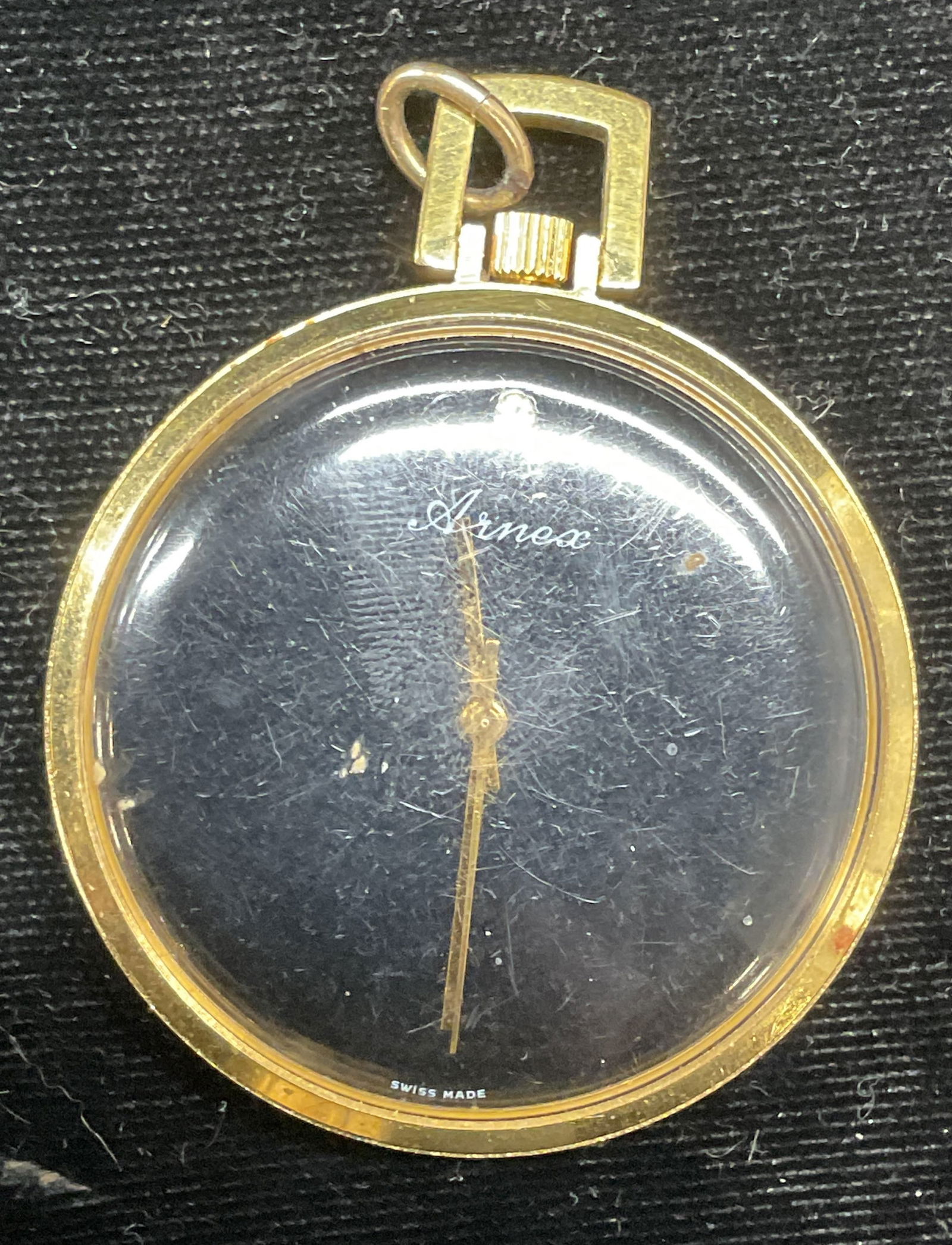 Arnex Gold Tone Pocket Watch: Arnex Swiss made gold tone black dial pocket watch. Signed. Measures approx 1.75 inches wide. Not tested. Some scratching. Jewelry, estate jewelry, costume jewelry, cocktail jewelry, fashion jewelry,