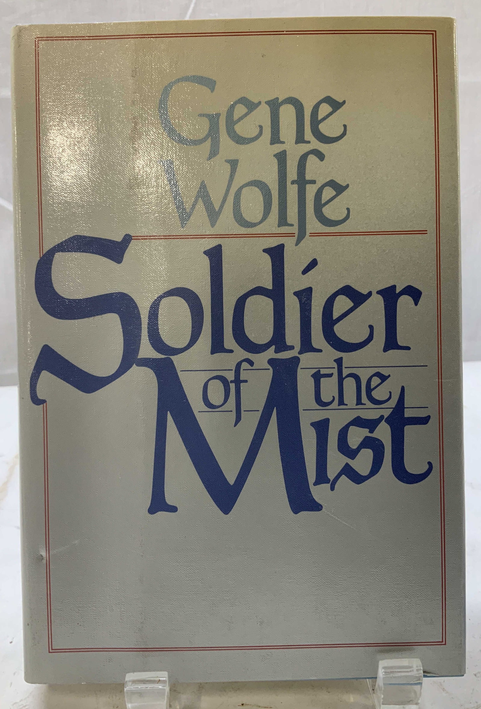 1986 Solider of the Mist First Print Book WOLF: Solider of the Mist by Gene Wolf. A Tom Doherty Associates Book. Copyright 1986. First printing. Printed in the United States. Front cover is grey toned. Surface wear consistent to age, use & exposure