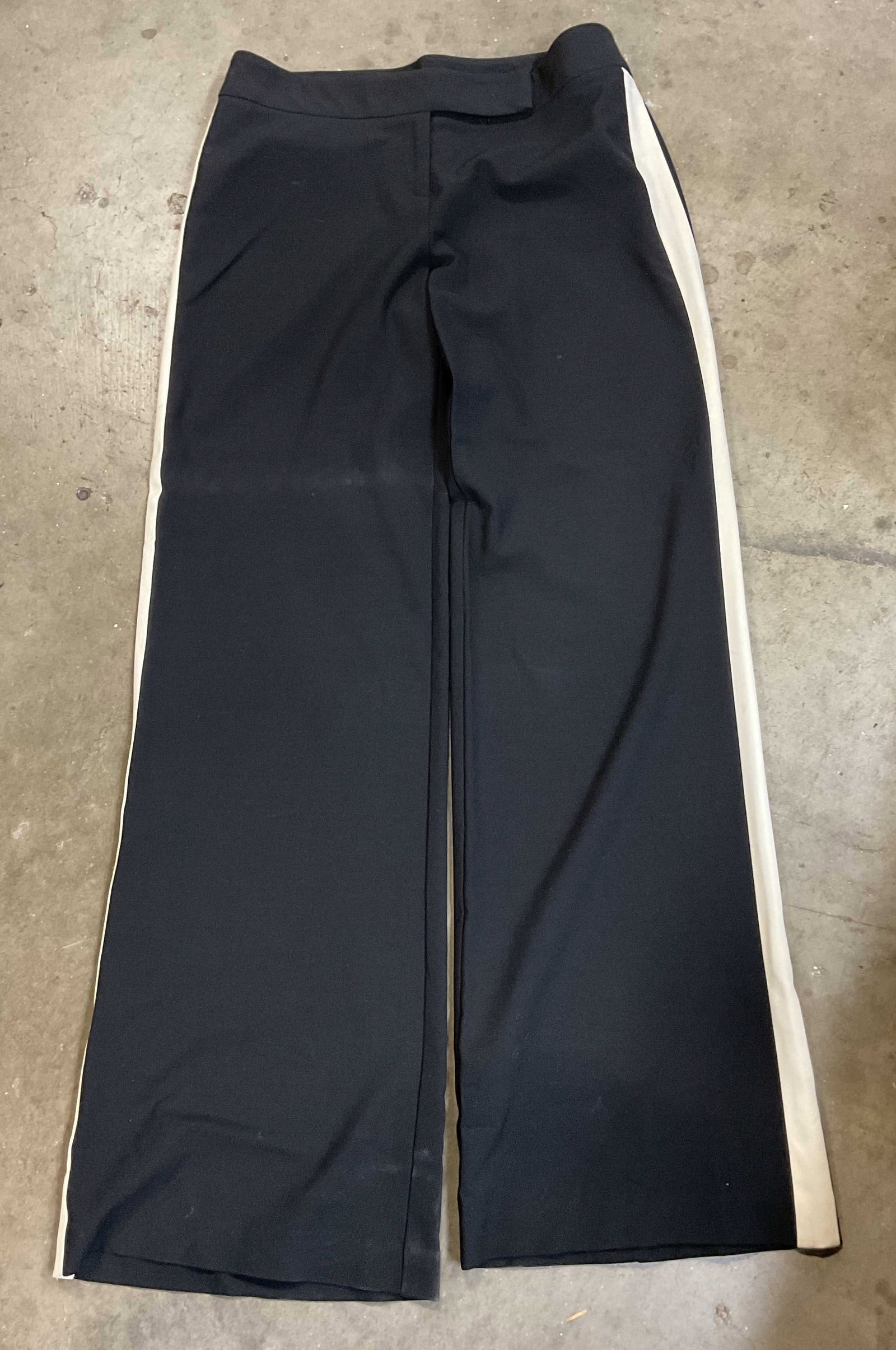 Launuky Black & White Trousers: Launuky black and white trousers. Size 4. Feels like synthetic material. Black pants with thick white stripe down each pant leg. Some blemishes and wear consistent with exposure. Property of 1980s kno