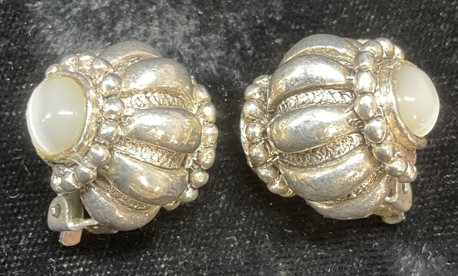 Vintage Silver Tone Iridescent Glass Earrings: Vintage silver tone cable motif earrings with white iridescent faux stone glass cabochons. Measure approx .75 x .75 inches. Some cabochons need replacement. Some scratching. Jewelry, estate jewelry, c