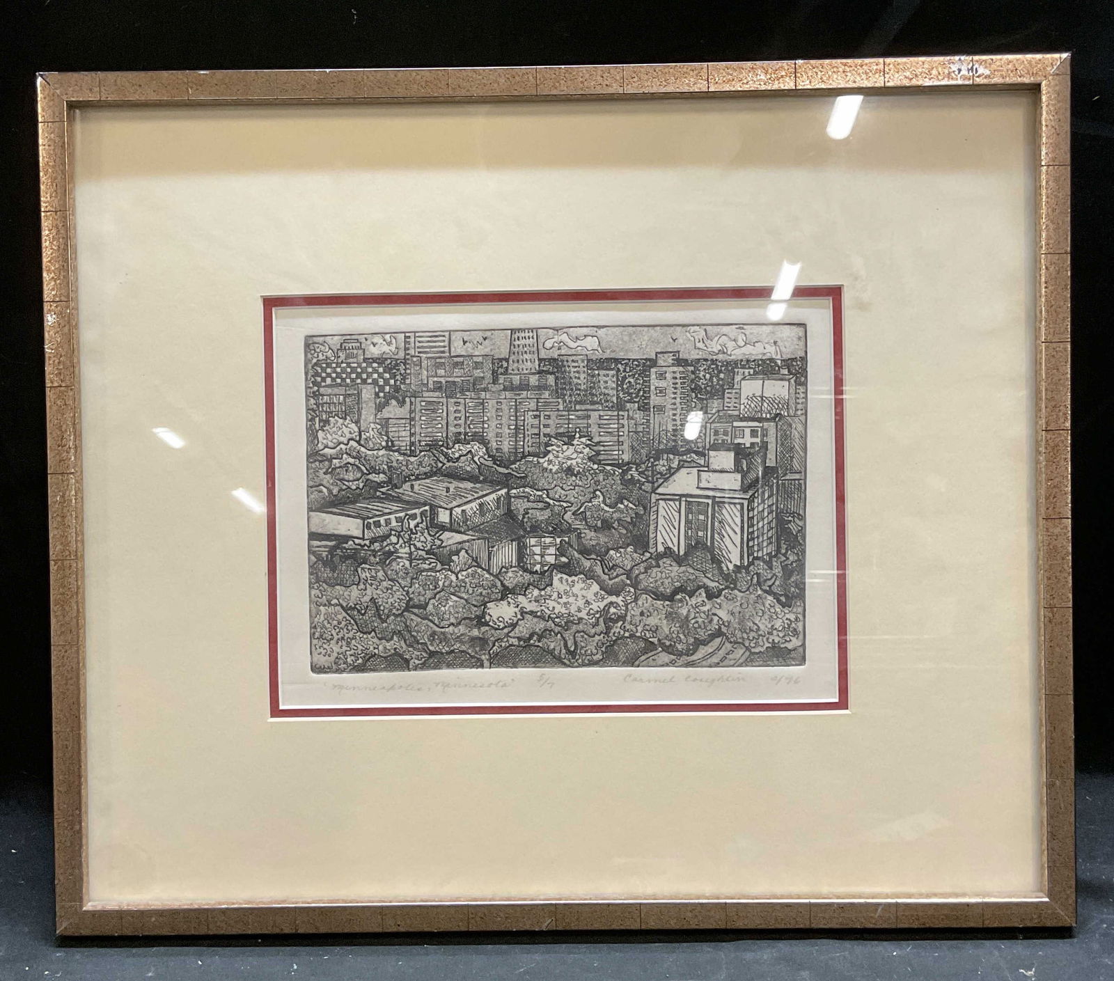 Signed Coughlin Minneapolis Cityscape Etching 1976: Framed and matted etching on paper. Signed Carmel Coughlin, 1976 at lower right. Edition number 5/7. Minneapolis, Minnesota. View of city from above. Wood frame. Not examined out o frame. Frame measur
