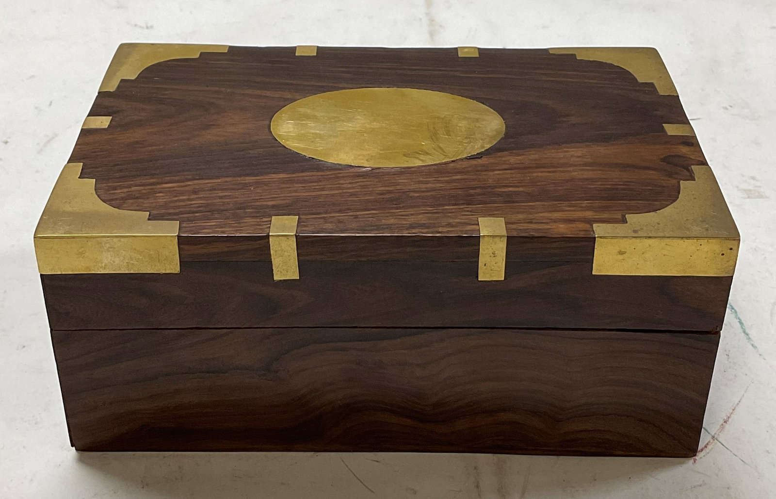 Rosewood & Brass Box W Lid: Rosewood and brass jewelry box with lid. Abstract design of brass accents inlaid on lid. Measures approx 7 x 4 1/2 x 3 inches. Some scratching observed and surface wear consistent with use and exposur