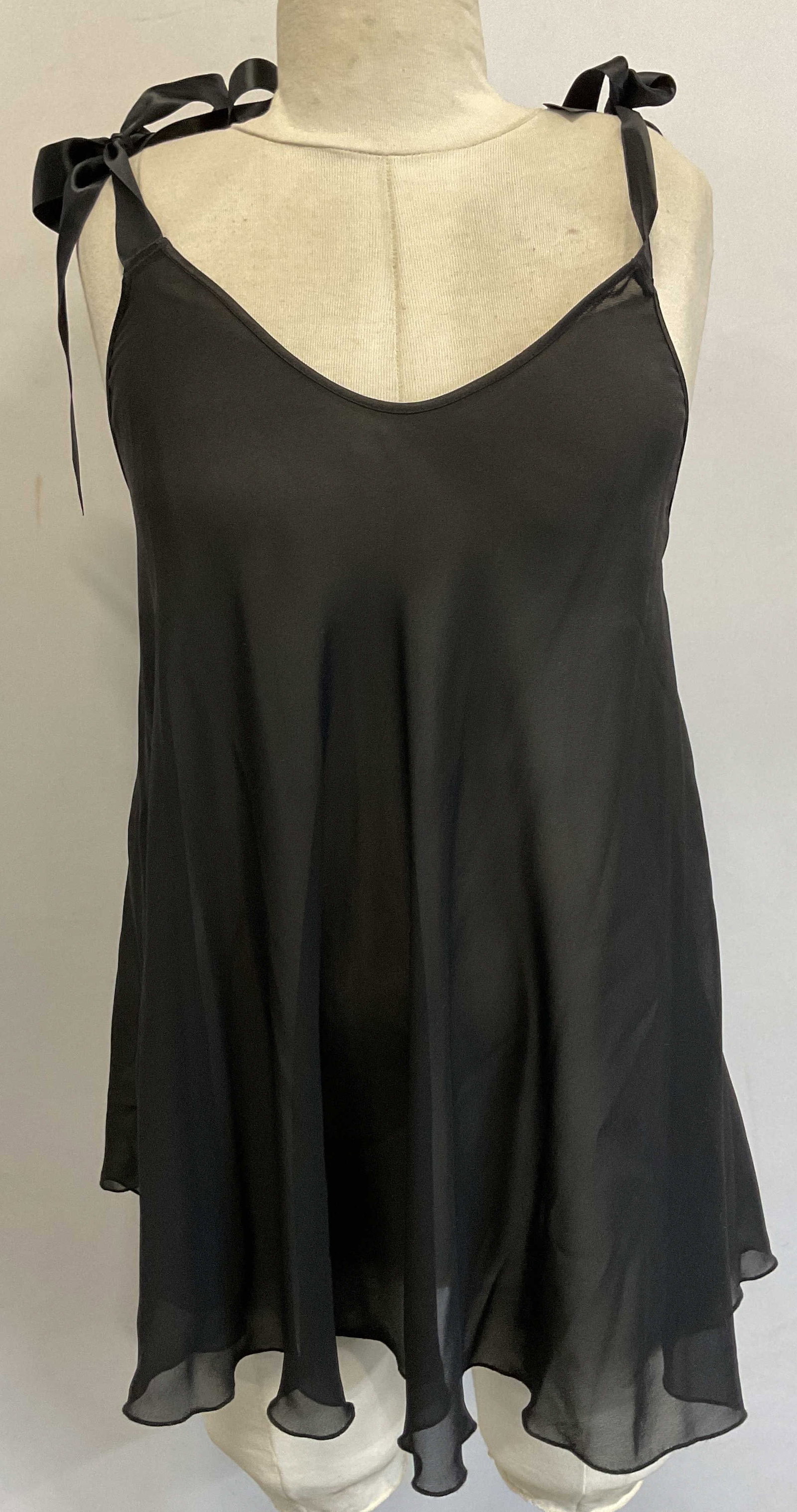 Victorias Secret Black Ribbon Sheer Top: Victorias Secret black ribbon sheer sleeveless top. Size S. Polyester material. Ribbons that tie as straps. Flowy align fit. Some blemishes observed and wear consistent with exposure. Property of 1980