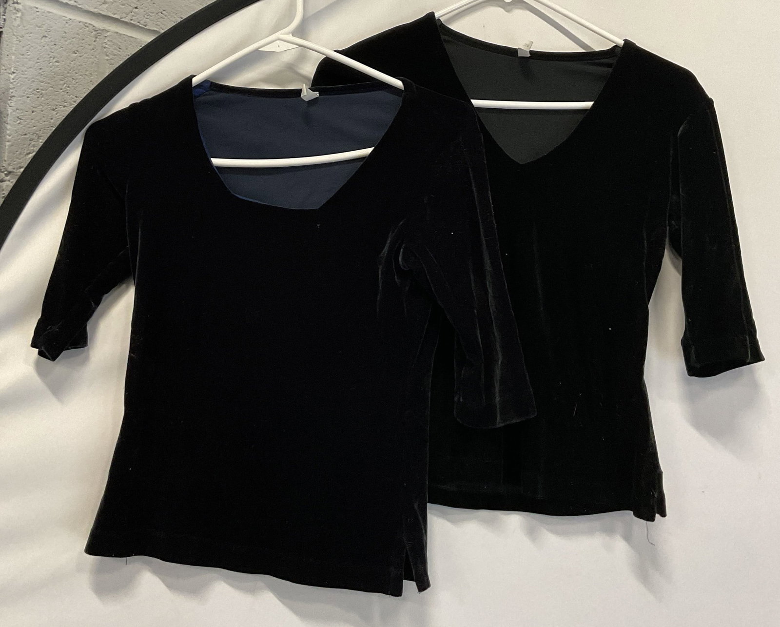 Lot 2 C. C. Outlaw Blue & Black Tops: Lot of 2 C. C. Outlaw blue and back quarter sleeve tops. Both are size S. Both feel like polyester and velvet. Black top has a v neckline and blue top has square like neckline. Split seam on both tops