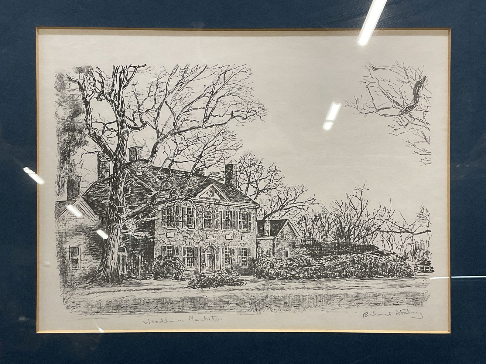 Framed Signed Woodlawn Plantation Lithograph: Framed and matted lithograph on paper. Hand signed lower right, illegible. Woodlawn Plantation, view of exterior home. Silver tone metal frame. Not examined out of frame. Frame measures approx 14 x 17