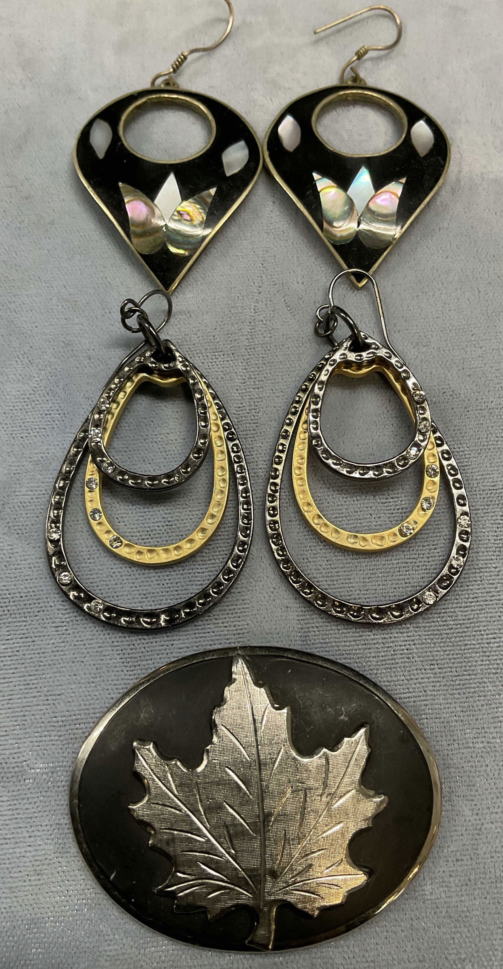 Lot 3 Alpaca Mother Of Pearl Earrings +: Lot of 3 jewelry pieces. Signed Alpaca silver tone and black mother of pearl and abalone inlaid drop earrings. Made in Mexico. Black and gold tone Crystal drop earrings. Silver tone and black leaf mot