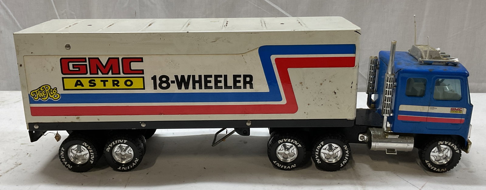 Vintage GMC Astro 18 Wheeler Toy Truck: Vintage GMC Astro 18 Wheeler toy truck. Enameled metal. Cab is blue with truck style features and red, white, and blue stripes across the door. Trailer is white with text reading The Rig, GMC Astro 18