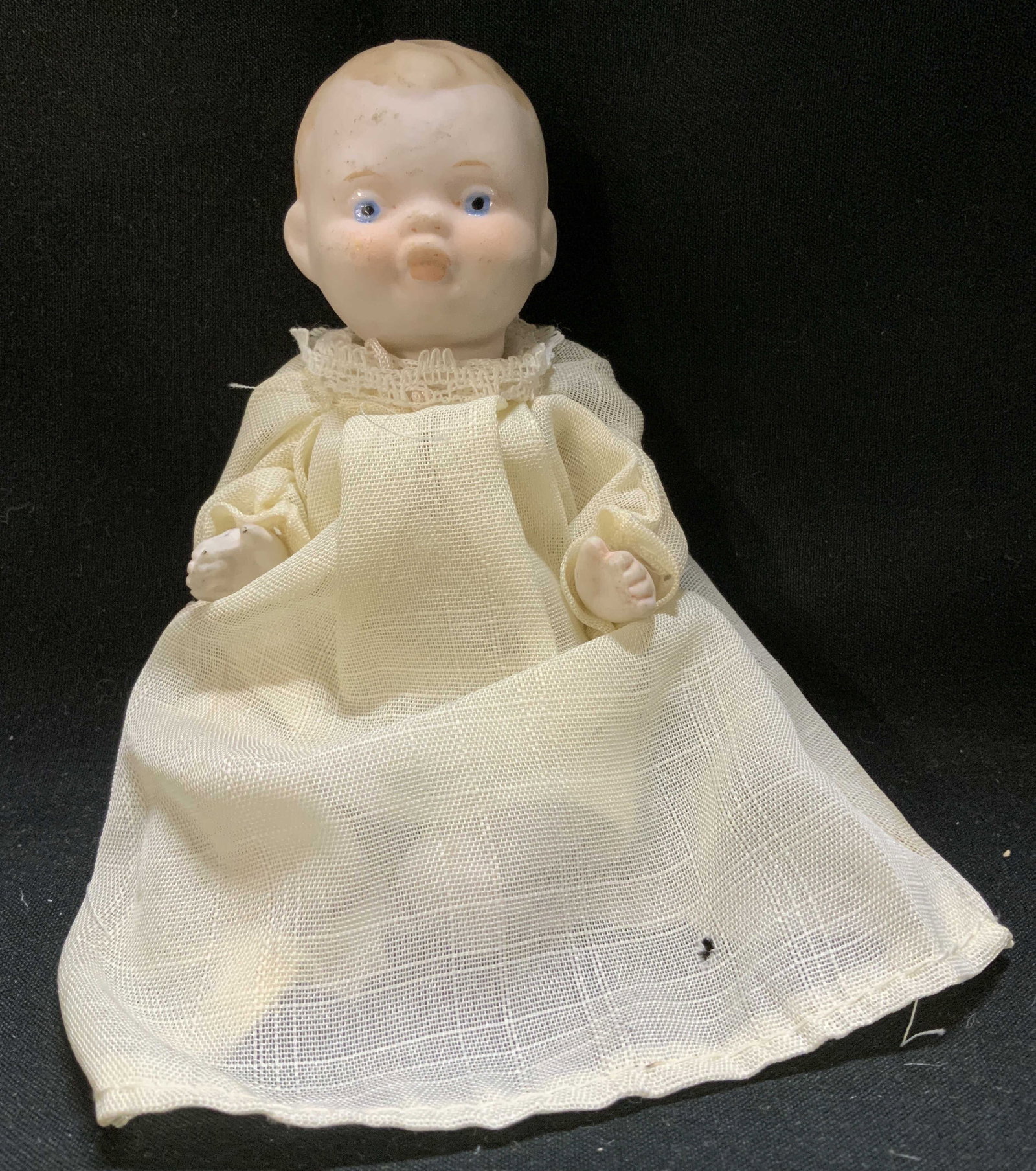 Vntg Hand-Painted Porcelain Baby Doll: Baby doll has a porcelain head, body, arms & legs. Face has hand-painted details. Doll is wearing a cream gown. No visible signature or markings. Surface wear consistent to age, use & exposure. Measur