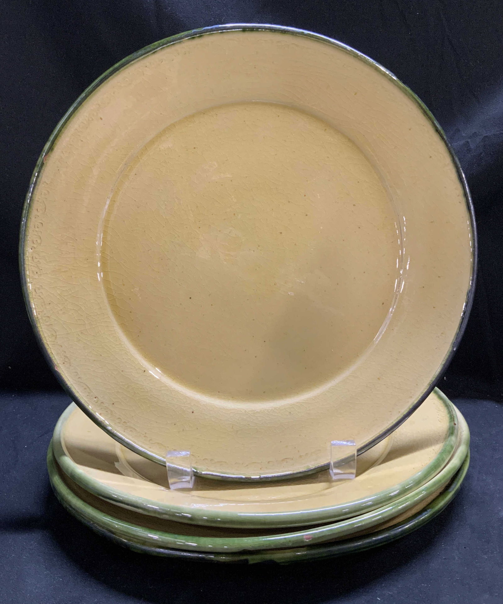 Set 4 Yellow & Green Glazed Ceramic Plates: Lot includes, 4 dinner plates w a yellow color & green trim. Glazed & glossy finish. No visible signature or markings. Surface wear consistent to age, use & exposure. Visible crazing. Measurements: le