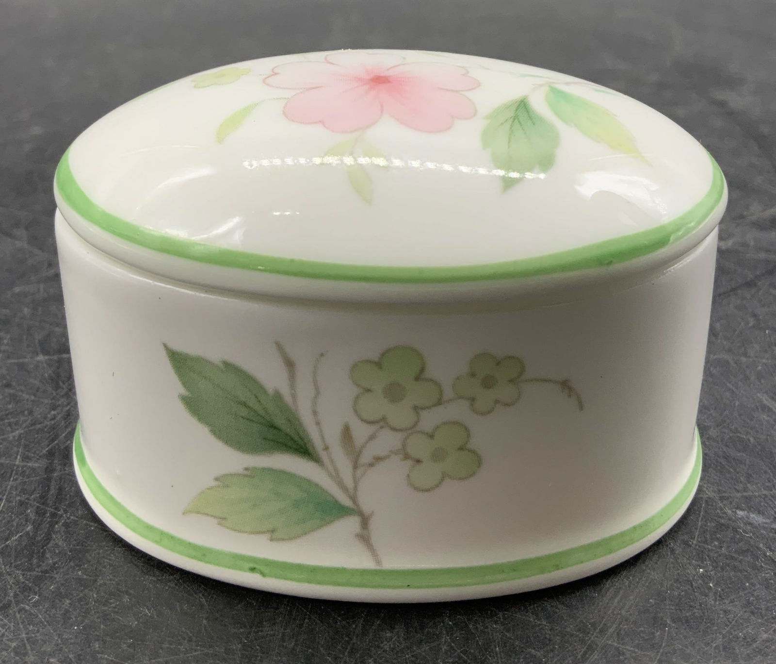 Victoria China Fine Bone China Pill Box ENGLAND: Pill box is fine bone china. Features pink & green floral motifs. Green trim. Signed & marked on underside. Reads, VICTORIA CHINA. FINE BONE CHINA. Made in England. Surface wear consistent to age, use