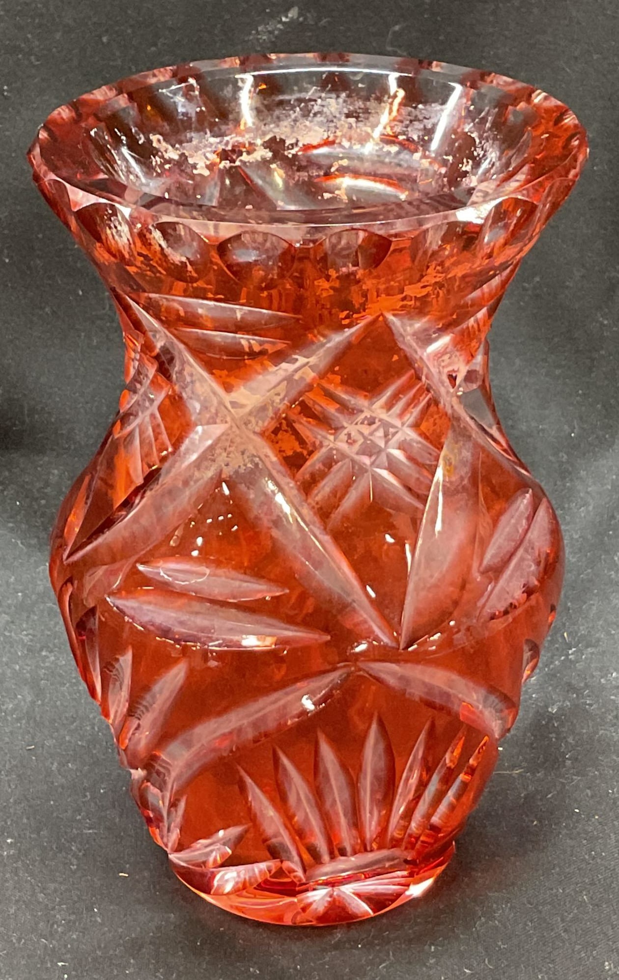 Vtg Ruby Cut To Clear Bohemian Glass Vase: Vintage ruby cut to clear Bohemian glass vase. Cut with ornate geometric and floral motifs. Scalloped rim which flares out to the body. Ruby color. Circular base with floral motif. Measures ht approx