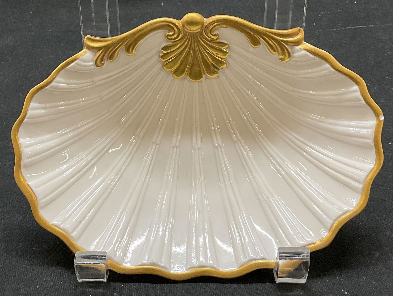 SGND Porcelain Gilt Shell Dish Italy: Signed porcelain gilt decorated shell dish. Signed and marked on underside, made in Italy. Underside reads as follows Porcellane DArte Bassano Italia Dr. Ermete Agostinelli. Cream colored with gilt sh