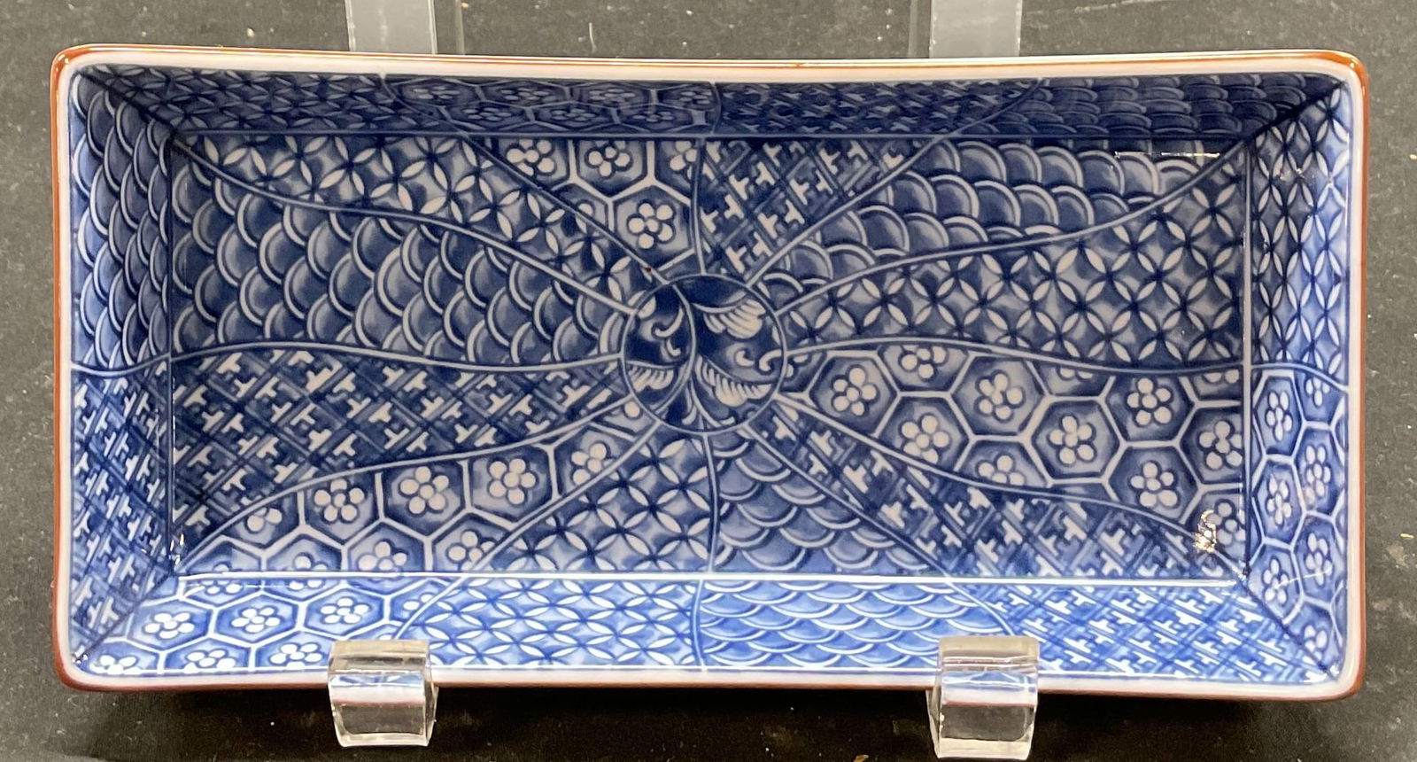 SGND Asian Blue & White Pattern Porcelain Dish: Signed Asian blue and white pattern porcelain dish. Signed on underside. Rectangular dish with flat base. Blue and white abstract floral pattern in and around dish. Brown line around rim. Measures app