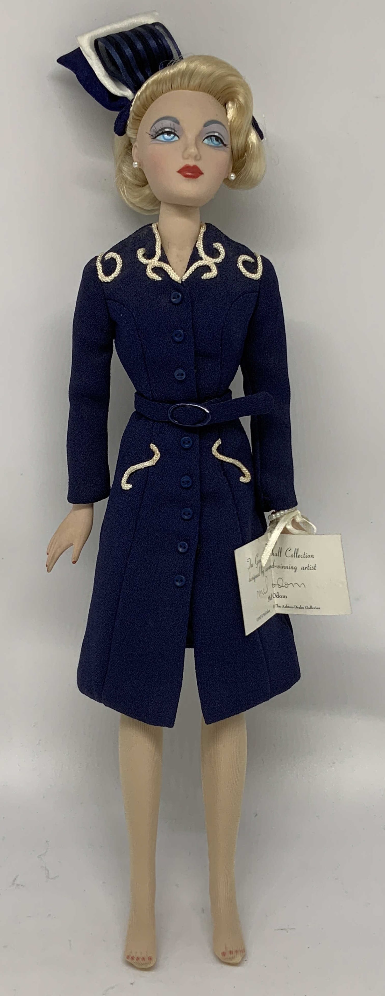 1995 Mel Odom Tea Time at Plaza Fashion Doll: Gene Marshall Tea Time at the Plaza fashion doll. Doll is dressed in a vintage style navy dress. Hand-painted features on face. Appears to be vinyl material. Comes with tags. Surface wear consistent t