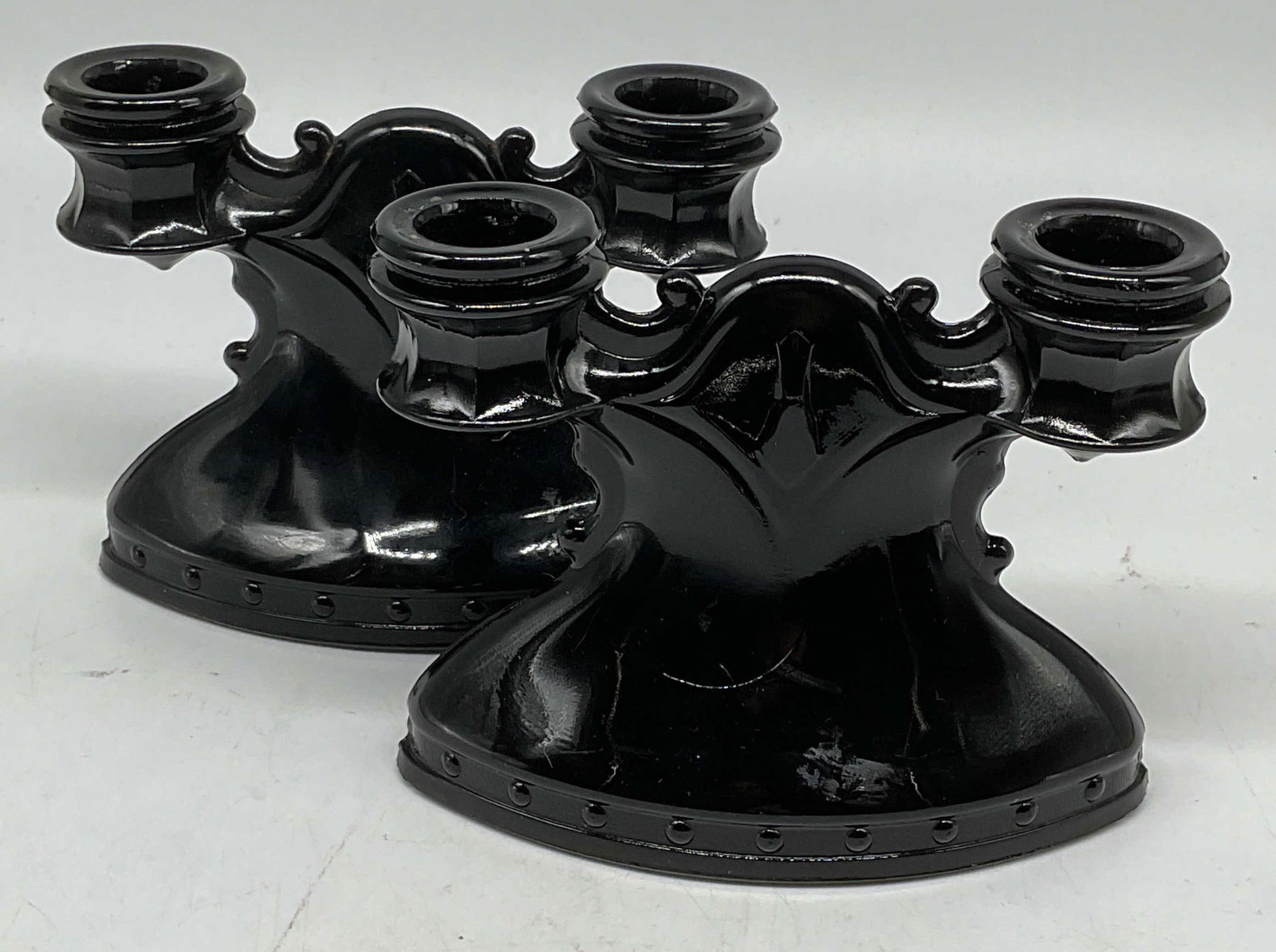 Pair Vtg L. E. Smith Black Glass Candlesticks: Pair of vintage black glass double candlesticks. Style of L. E. Smith, no visible signature or marks. Measure approx 5.75 x 2.75 x 4.5 inches. Some scratching. Black candlestick, glass candlestick, do