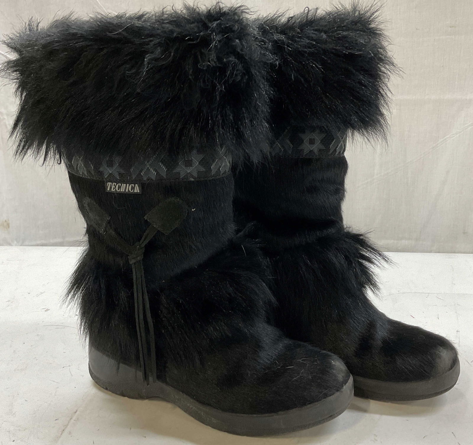 Tecnica Black Fur Ski Books Italy: Tecnica black fur ski boots. Made in Italy. Size 7. Feels like fur material. Fur throughout boot with geometric embroidered pattern. Some wear consistent with use and exposure. Boots, ski boots, winte
