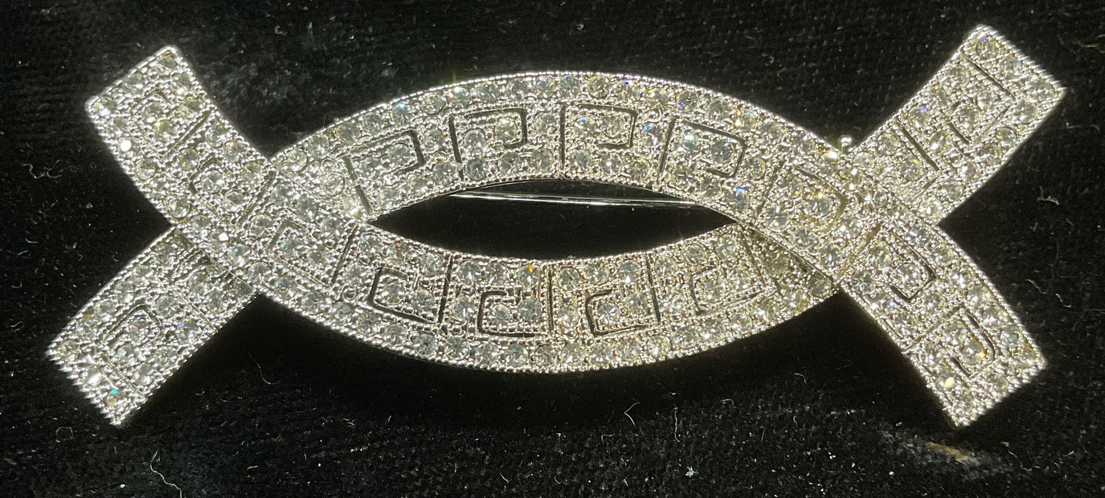 Silver Tone Curved Crystal Brooch: Silver tone colorless crystal crossed curved shaped brooch. Measures approx 1 x 2.75 inches. Some scratching. Jewelry, estate jewelry, costume jewelry, cocktail jewelry, fashion jewelry, accessories,