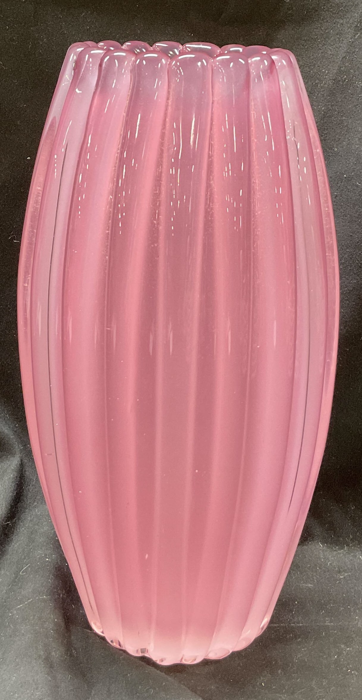 Murano Hand blown cased pink art glass vase: Hand blown art glass vase. Clear and pink glass. Raised scalloped design. Style of Murano no visible signature. Measures ht approx 9 1/2 inches diam approx 4 inches. Some scratching observed. Blown gl