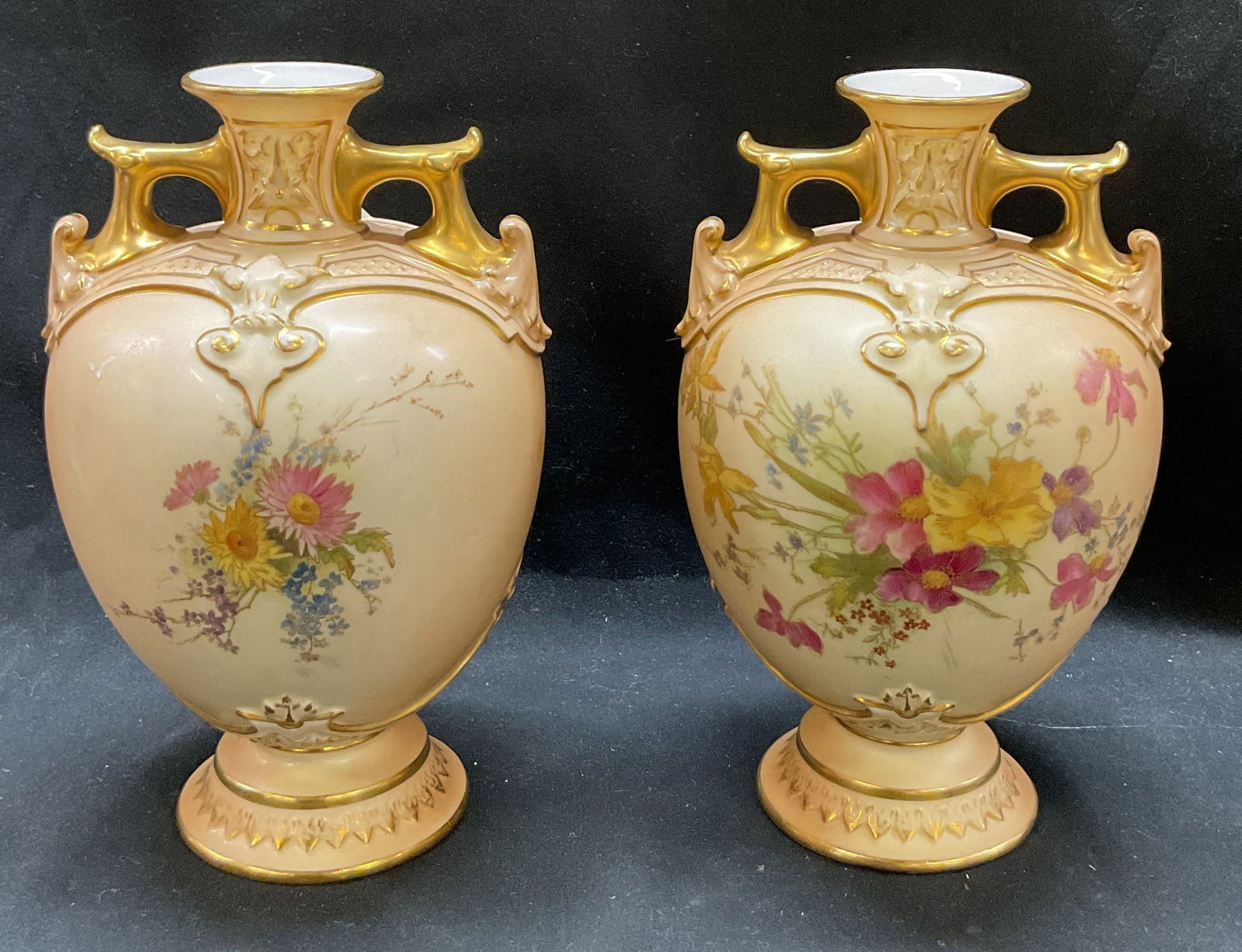 SGND Pair antique Royal Worcester Porcelain Urns: Signed and trademarked on underside. Reads Royal Worcester England style number 1654. Potters marks on underside. Narrow neck embossed with gilt porcelain. Double handles. Raised scroll design. Hand p