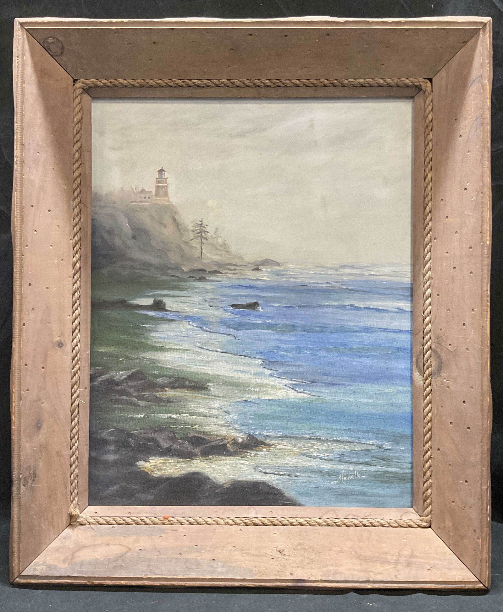 Signed Michelle Ocean Lighthouse Oil Painting: Framed oil on canvas painting. Signed Michelle at lower right. View of ocean with lighthouse in distance. Rustic wood and rope accent frame. Not examined out of frame. Frame measures approx 25.5 x 21