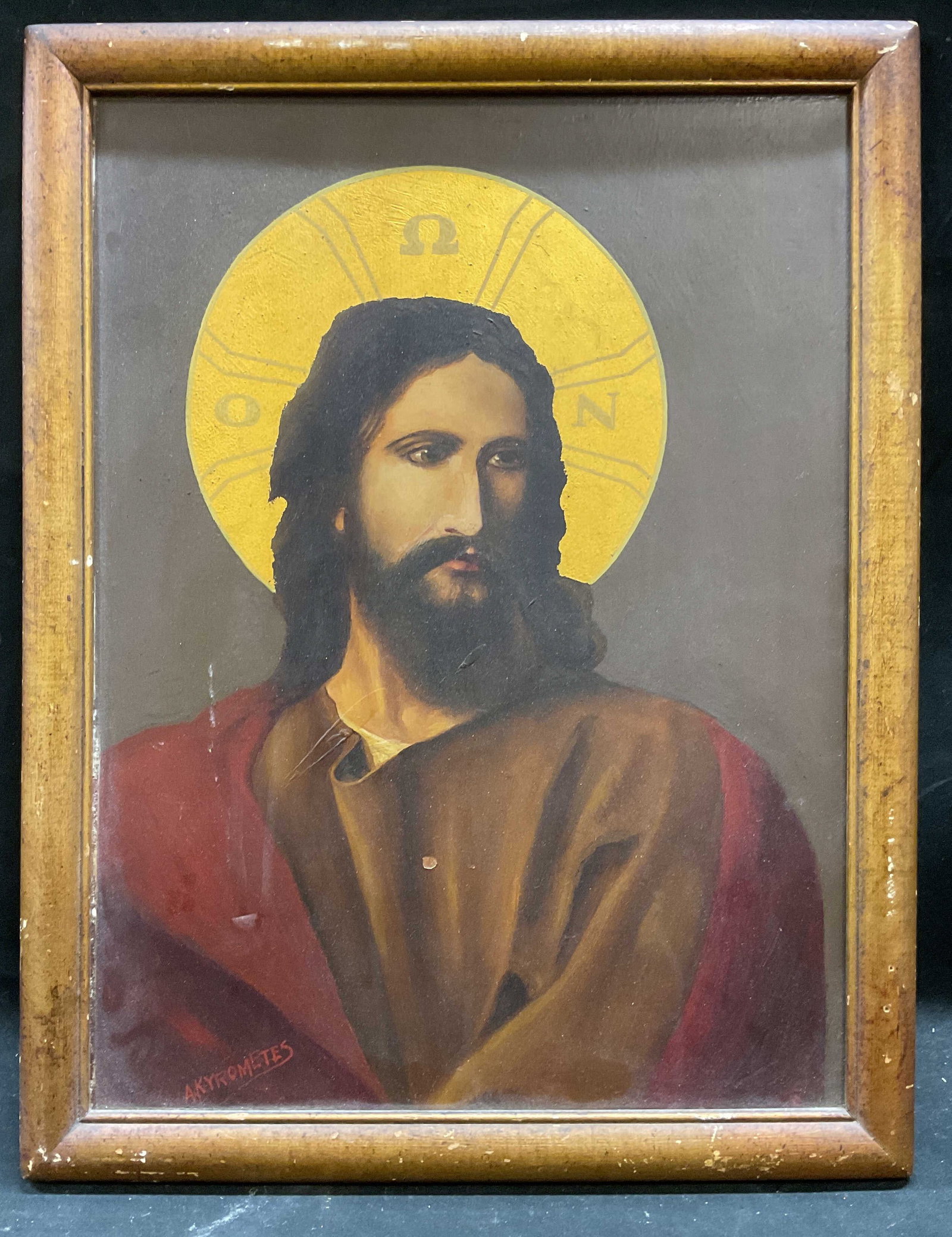 Signed Akyrometes Icon of Christ Oil Painting: Framed oil onboard painting. Signed lower left Akyrometes. Green icon painting. Jesus Christ. Gilt decoration. Wood frame. Not examined out of frame. Frame measures approx 17 x 13.5 inches. Wear inclu