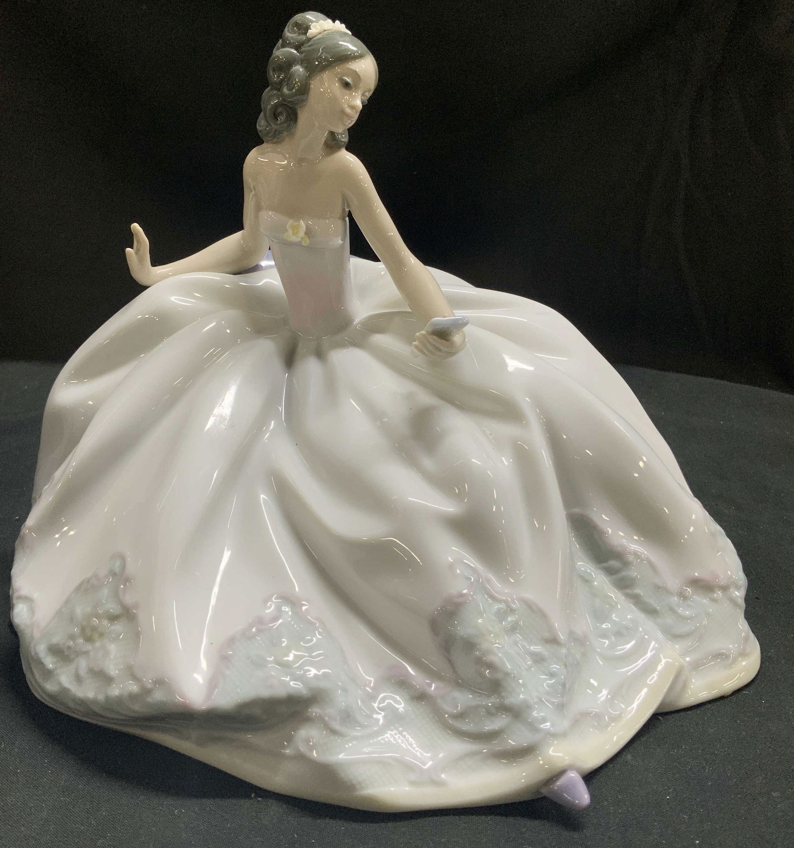Sgnd Lladro At the Ball Woman Porc Figurine SPAIN: Figurine depicts a woman seated & in a flowing ball gown w floral accents. Glossy finish & hand made. Signed & marked on underside. LLADRO. MGE 88. HAND MADE IN SPAIN. DAISA 1991. Visible signature. S