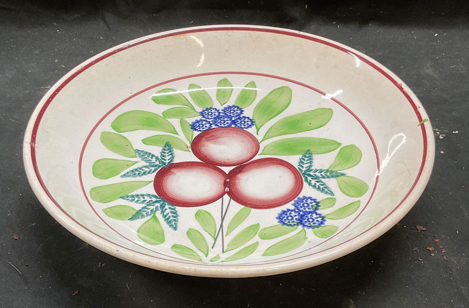 Societe Ceramique Maastricht Spongeware Bowl Holland: Antique Societe Ceramique Maastricht ceramic bowl. Cut Spongeware, hand painted. Plum and flower design. Signed with Backstamp. Made in Holland. Measures approx 11 x 2.25 inches. Wear including crazin