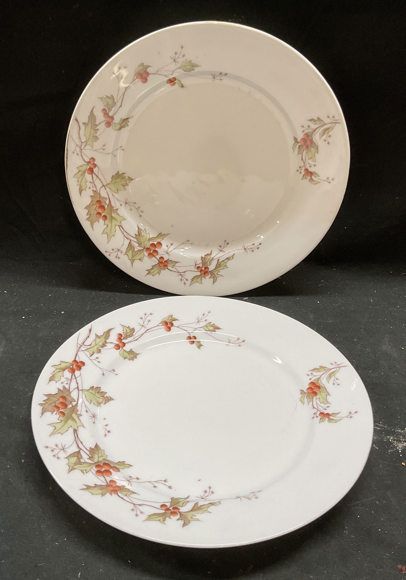 Pair Antique Signed Austrian China Golly Plates: Pair of antique China plates. Signed with Backstamps. Marked Austrian China. Christmas pattern, holly branches. Hand painted. Measure approx 9.25 inches wide. Some scratching, chipping to underside of