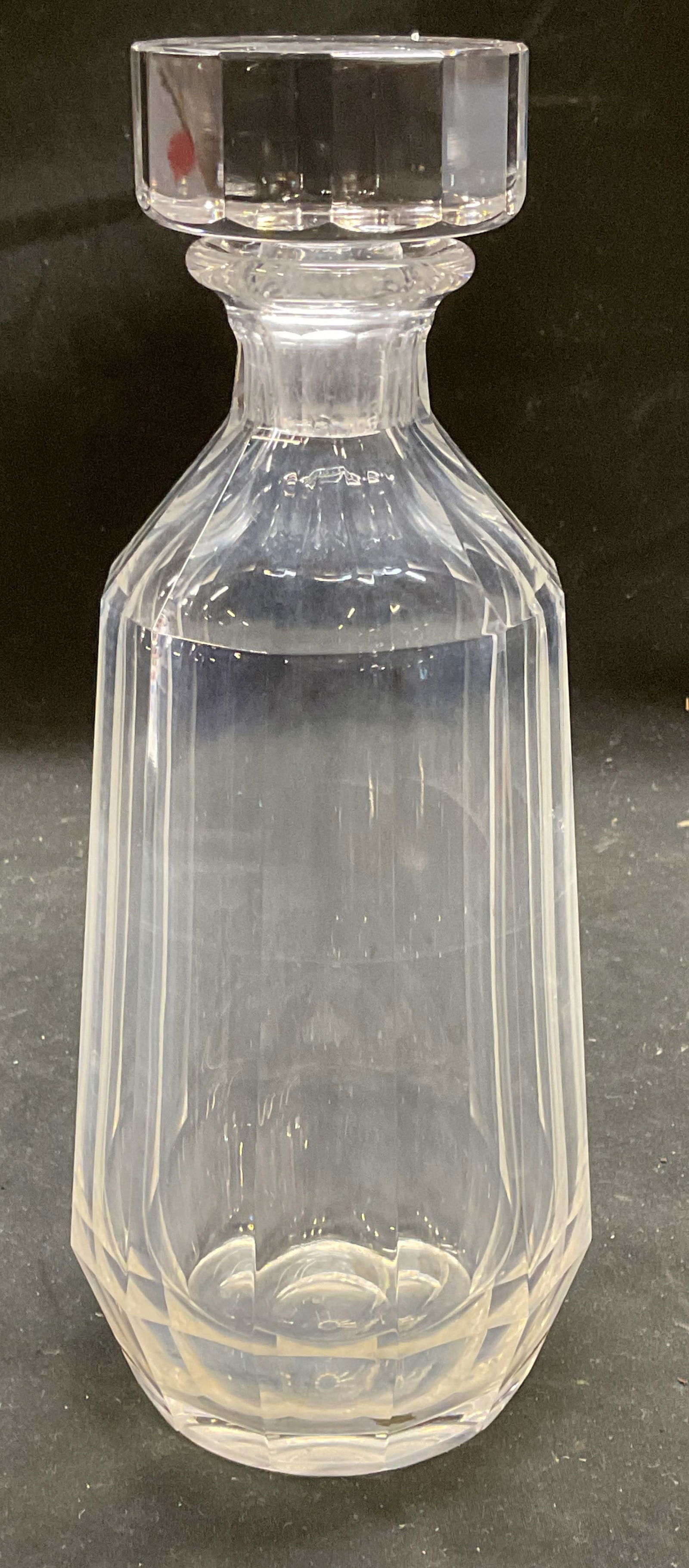 Vintage Signed Faceted Crystal Decanter: Vintage signed crystal decanter. Tapered faceted design and faceted stopper. Signed on underside, possibly Kosta. Measures approx 3.75 x 9 inches including stopper. Some scratching. Crystal decanter,
