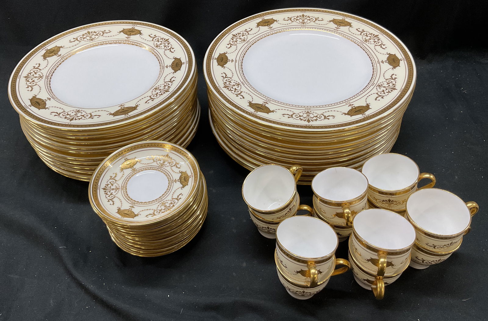 Set 47 Mintons Gilt Porcelain Tableware England: Set of 47 piece antique Mintons gilt porcelain tableware set. Made in England. Includes 12 demitasse cups, 12 saucers, 11 dinner plates, and 12 luncheon plates. Signed and marked on underside. Undersi