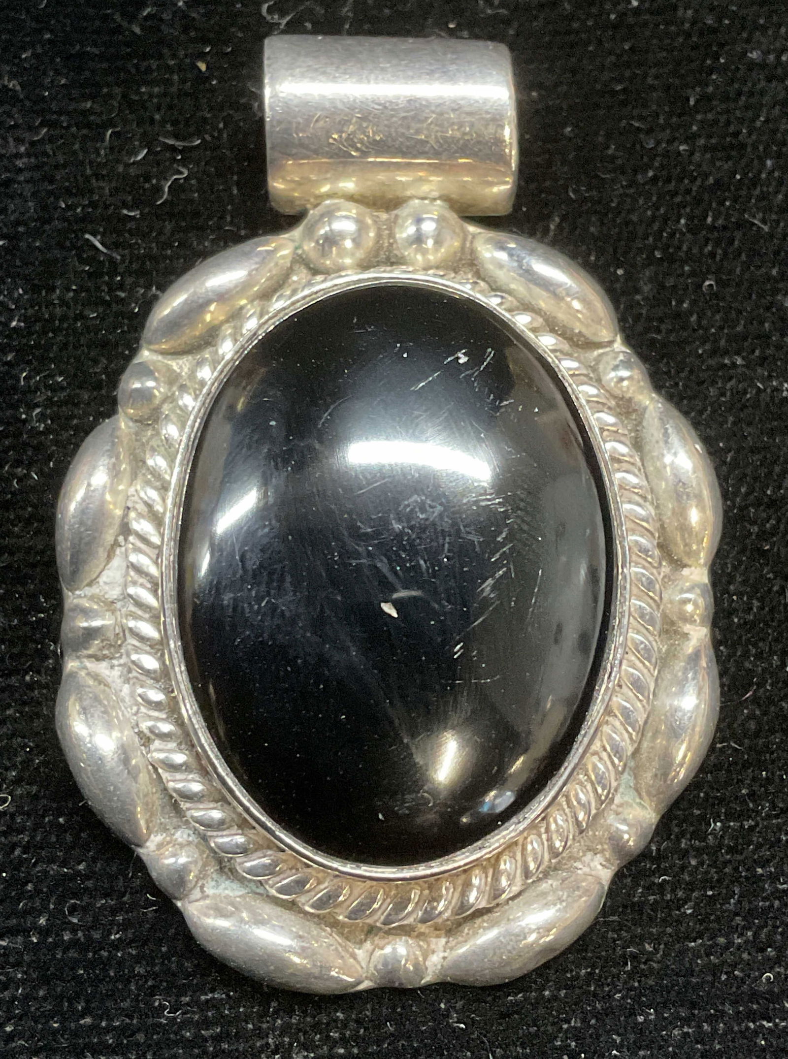 Sterling Silver Black Onyx Pendant, Mexico: Vintage sterling silver and black onyx cabochon pendant. Marked sterling. Made in Mexico. Measures approx 1.5 x 1.25 inches. Total weight 23.3 grams. Some scratching. Jewelry, estate jewelry, fine jew