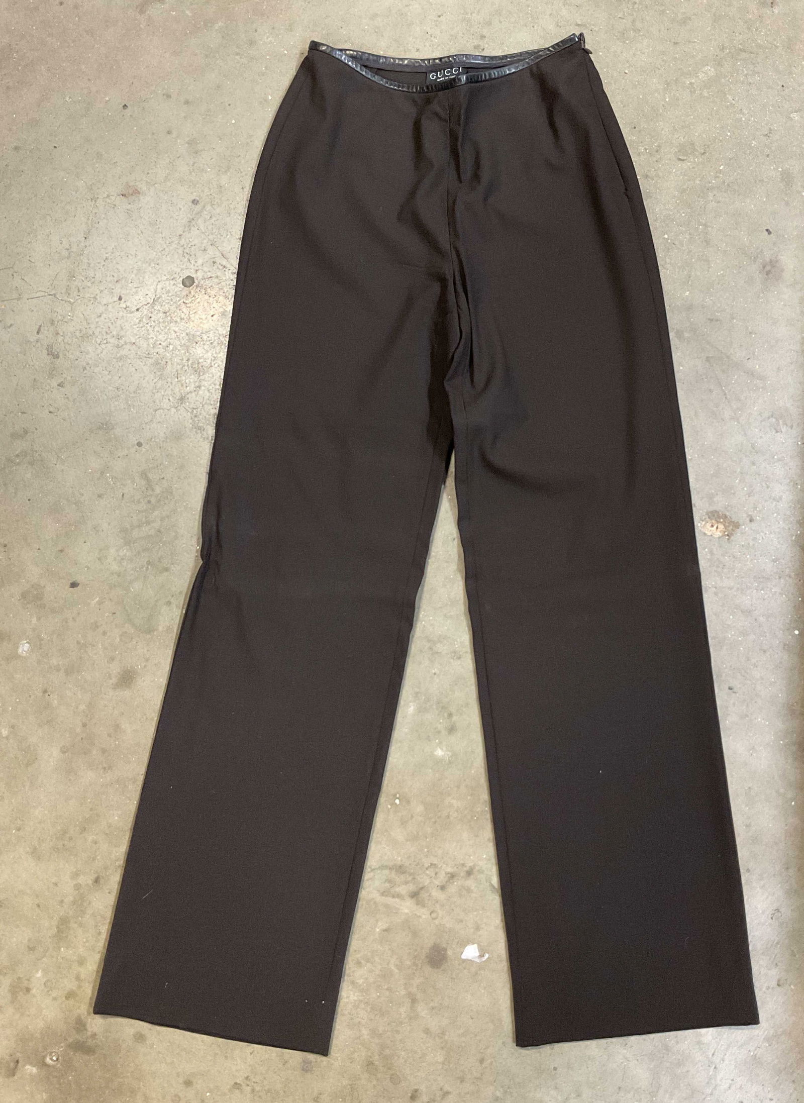 Gucci Dark Brown Trousers Italy: Gucci dark brown trousers. Made in Italy. Measures approx 14 inches across waist. Wool material. Possibly leather waistband. Size zipper. Some wear consistent with exposure. Property of 1980s known Ro