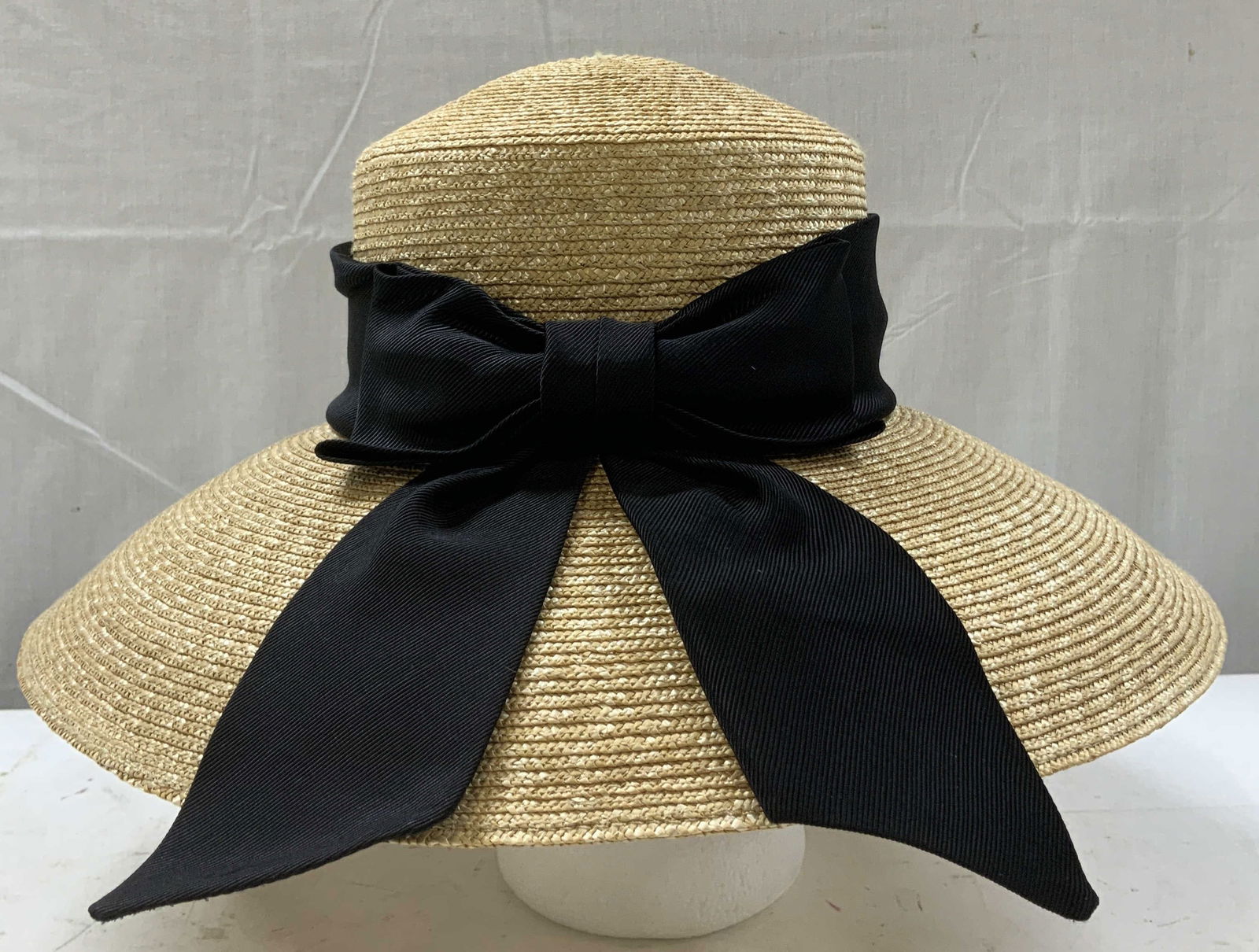 Callanan Millinery Wheatbraid Hat W Bow Accent: Callanan Millinery hat in natural wheatbraid & polyester. Hat features a black accent bow. Wide brim. Signed & marked. Reads, EUROPEAN DESIGNER. CALLANAN. MILLINERY. AMERICAN STYLE. ONE SIZE. JJ. HAT