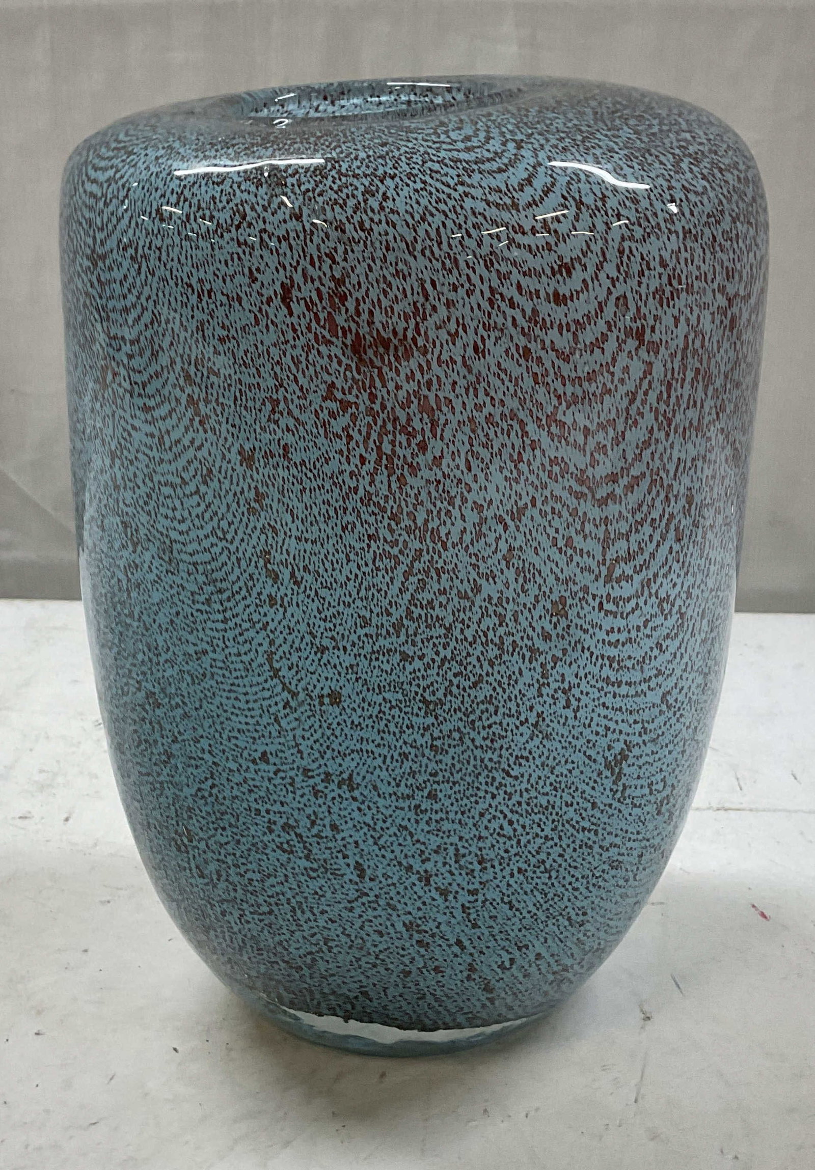 Sun Life Art Glass Deco Vase: Sun Life art glass deco vase. Speckled abstract design in blue and reddish brown. Appears to be textured. Cylinder body with curved top rim. Measures ht approx 9 inches diam approx 6 1/2 inches. Surfa