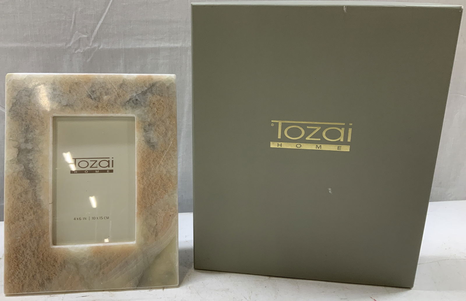 Tozai Home Quartz Photo Frame With Box INDIA: Tozai home Quartz rectangular photo frame. Pink, grey & white tones. Frame has weight. Comes with original box. Surface wear consistent to age, use & exposure. Signed & matted. Reads, TOZAI HOME. MADE