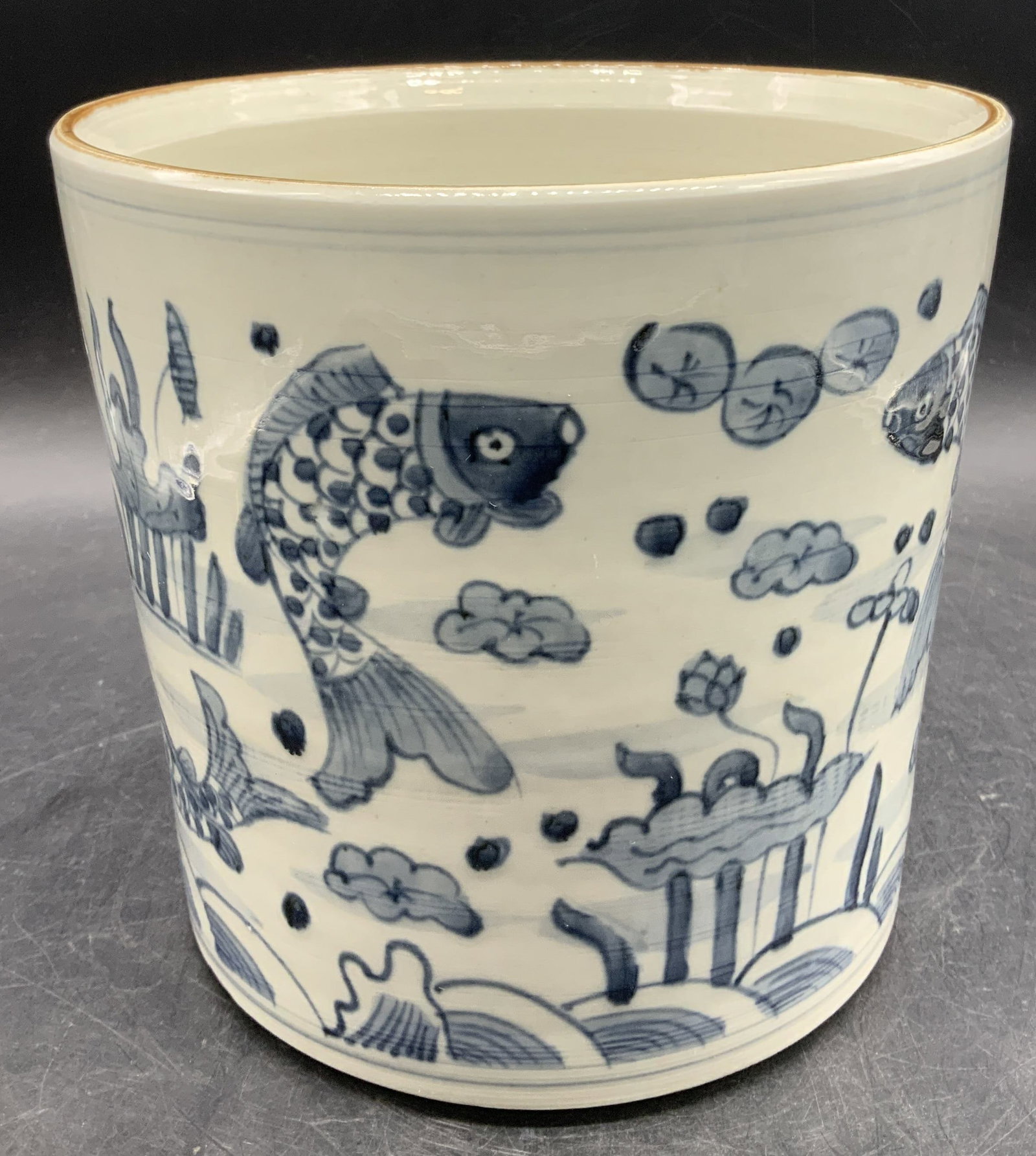 Hand Painted Koi Fish Porcelain Planter: Planter is porcelain material & features hand-painted koi fish w floral motifs. Light blue toned w brown trim. Glossy finish. Surface wear consistent to age, use & exposure. Measurements: length 7.7in