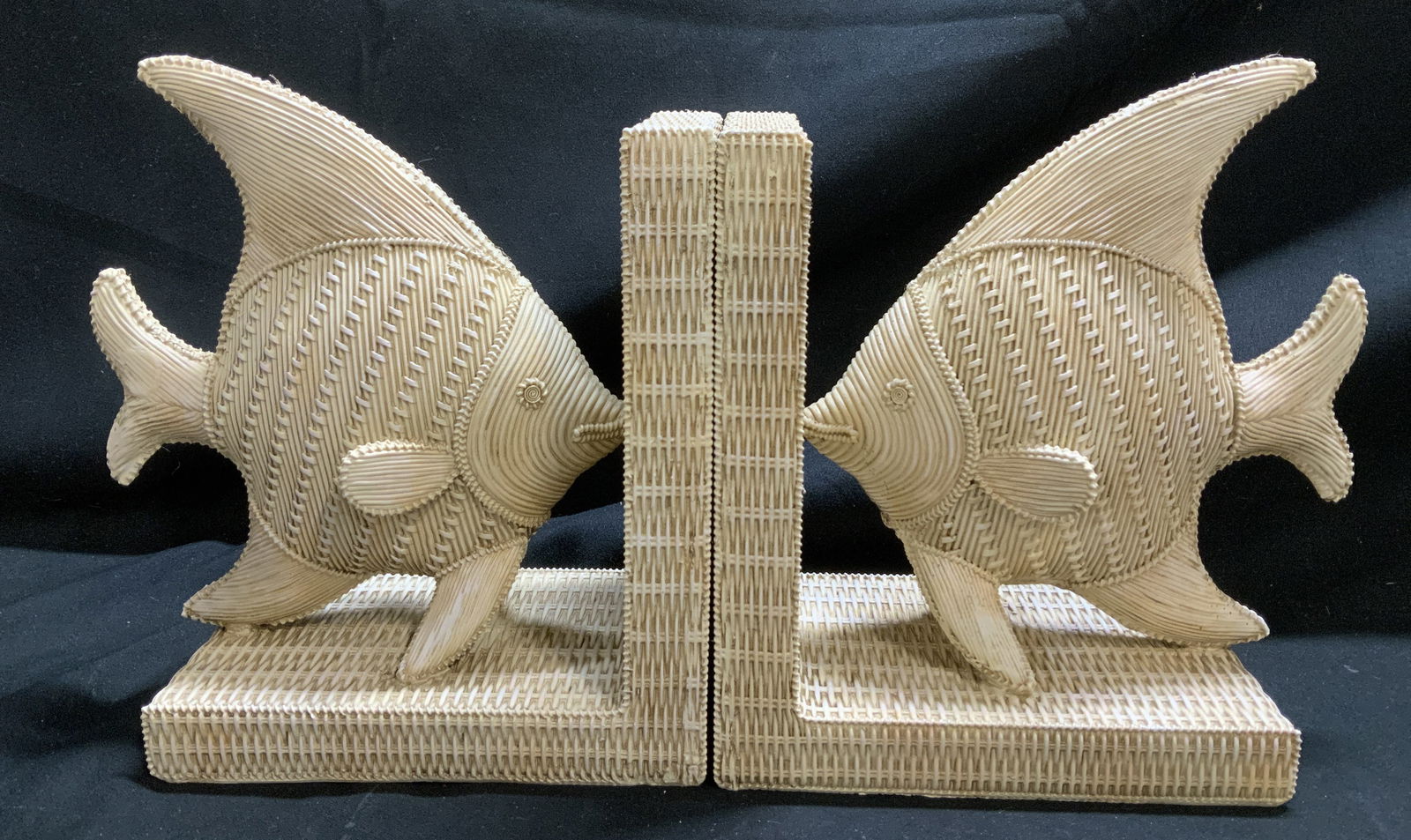 Pair Resin Basket Weave Style Fish Bookends: Pair of decorative resin bookends mimicking a basket weave texture. Bookends depict fishes facing each other. Cream toned. Surface wear consistent to age, use & exposure. Measurements: length 6.5in x