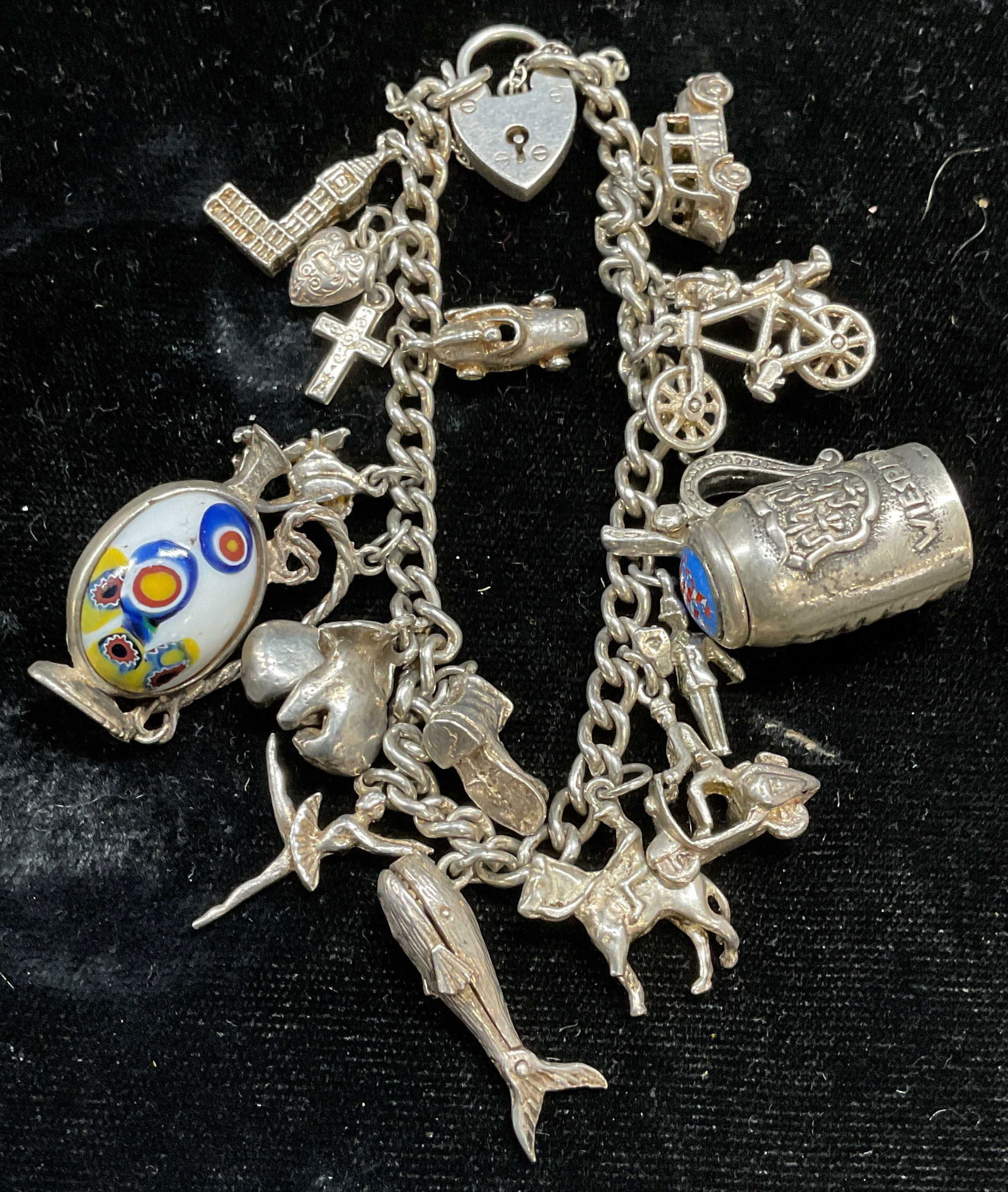 Vtg Signed Sterling & 835 Silver Charm Bracelet: Vintage signed charm bracelet. Signed illegibly, lion passant silver mark. One pendant marked 835 silver. Assorted charms, whale, boot, gloves, ballerina, equestrian, cross, heart, bicycle, and more.