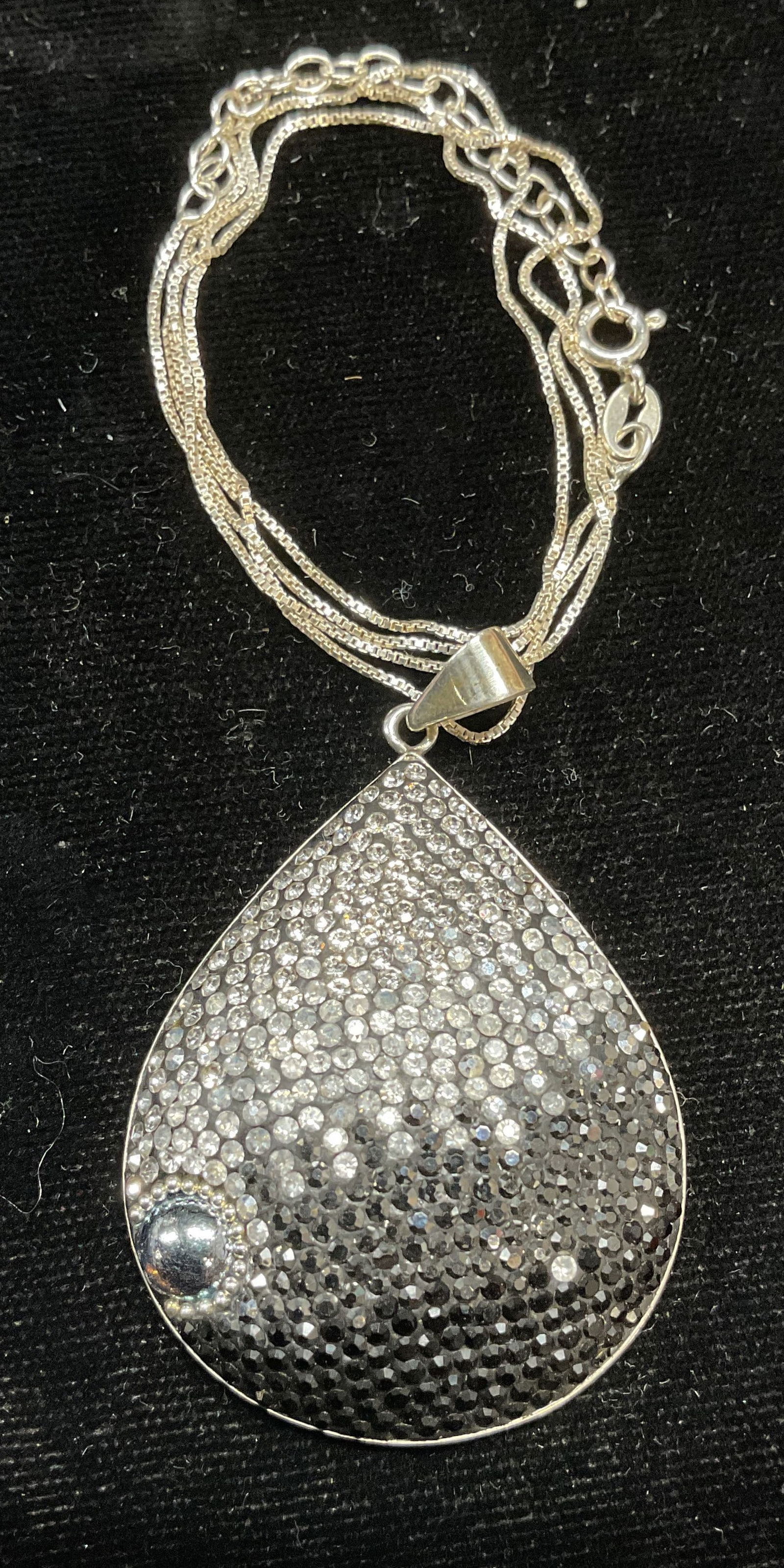 Sterling Silver Crystal Pendant Necklace, Italy: Sterling chain necklace with sterling silver black and colorless crystal teardrop pendant. Marked sterling. Necklace made in Italy. Drop length approx 10 inches. Pendant approx 1.75 inches long. Total