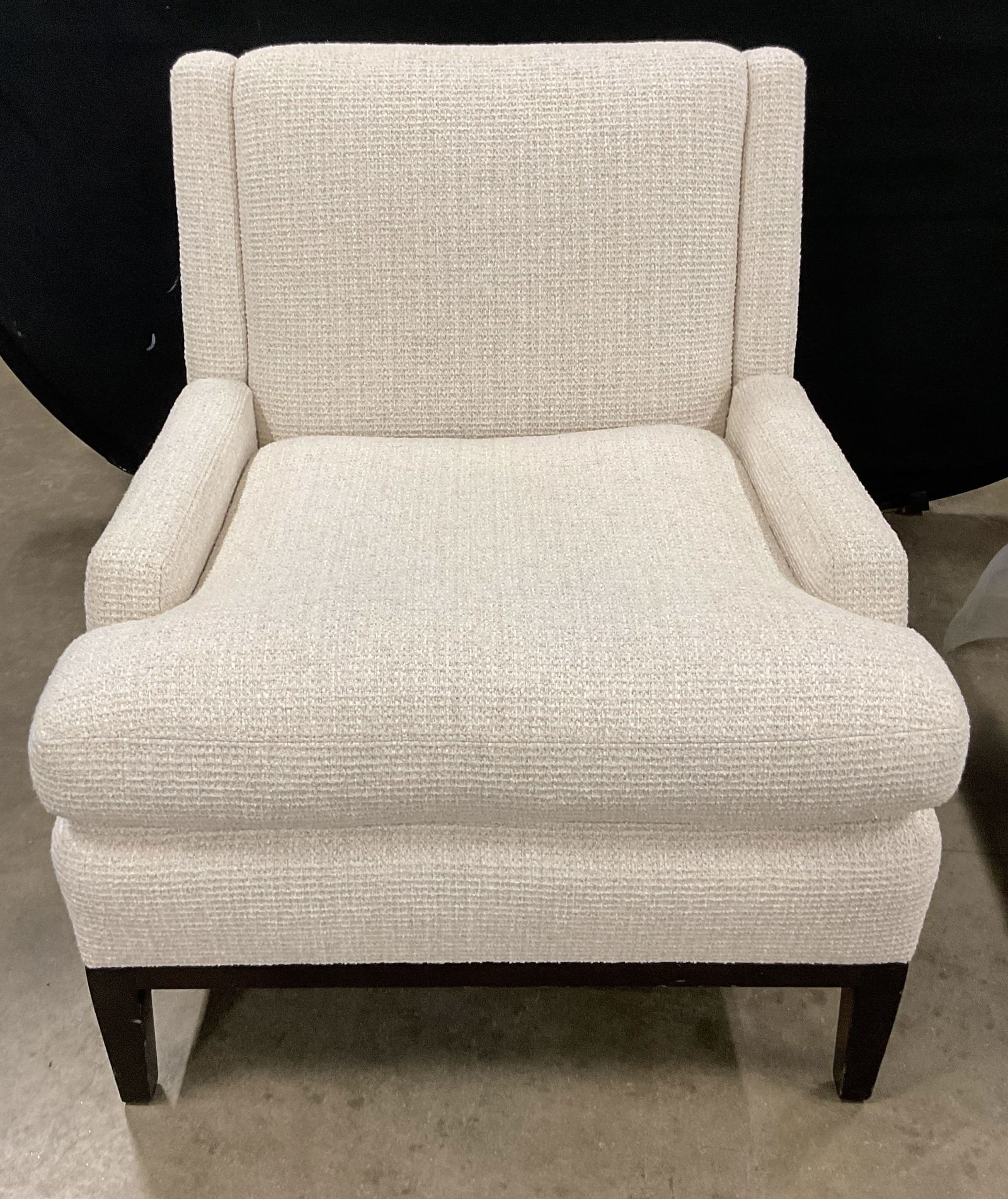 Modern White Upholstered Armchair: Modern style upholstered armchair. White textured tweed upholstery, dark wood legs and frame. Measures approx 29.5 x 32.5 x 33 inches. Some scratching. property of park Avenue Manhattan estate sourced
