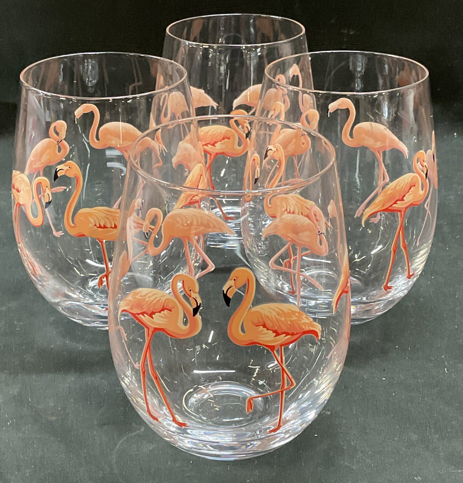 Set 4 Tropical Flamingo Stemless Wine Glasses: Set of 4 tropical pink flamingo pattern stemless wine glasses. Measure approx 3.5 x 5 inches. Minimal wear consistent with exposure. Flamingo glasses, wine glasses, stemless wine glasses, Barware, bar
