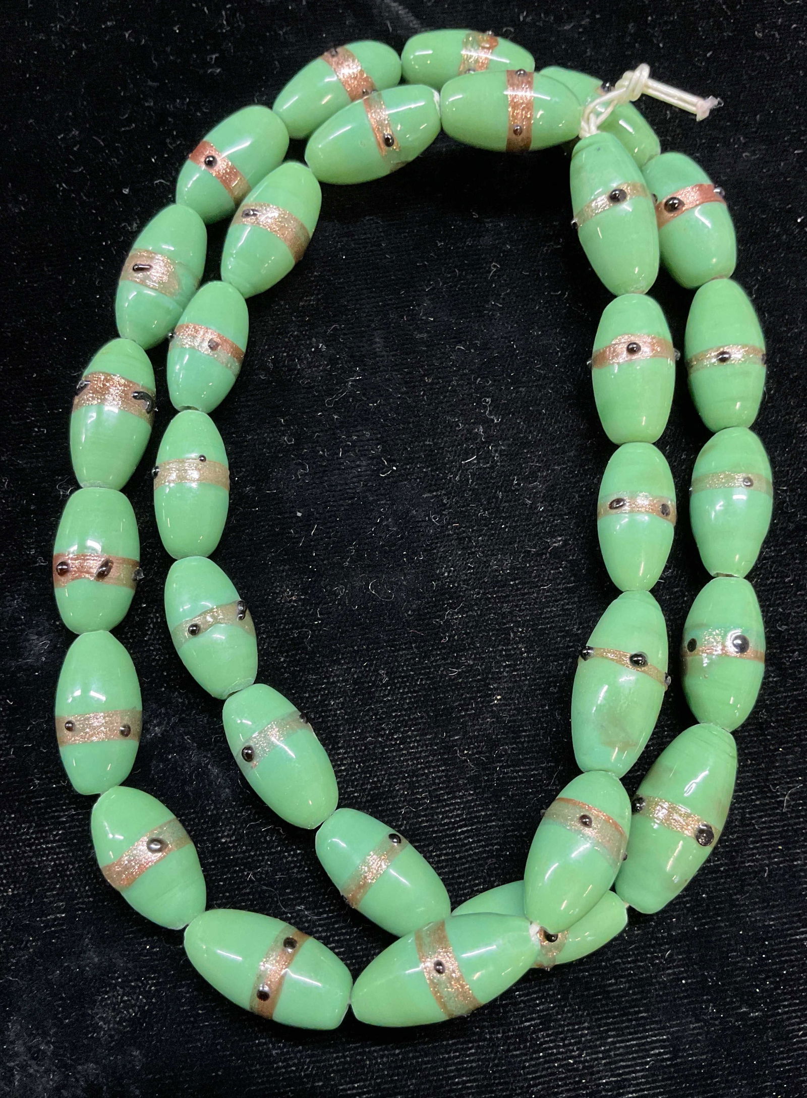 Hand Blown Green Art Glass Beaded Necklace: Hand blown art glass beaded necklace, green beads with gold flecks and raised black dots. Drop length approx 11.5 inches. Some scratching. Jewelry, estate jewelry, costume jewelry, cocktail jewelry, f