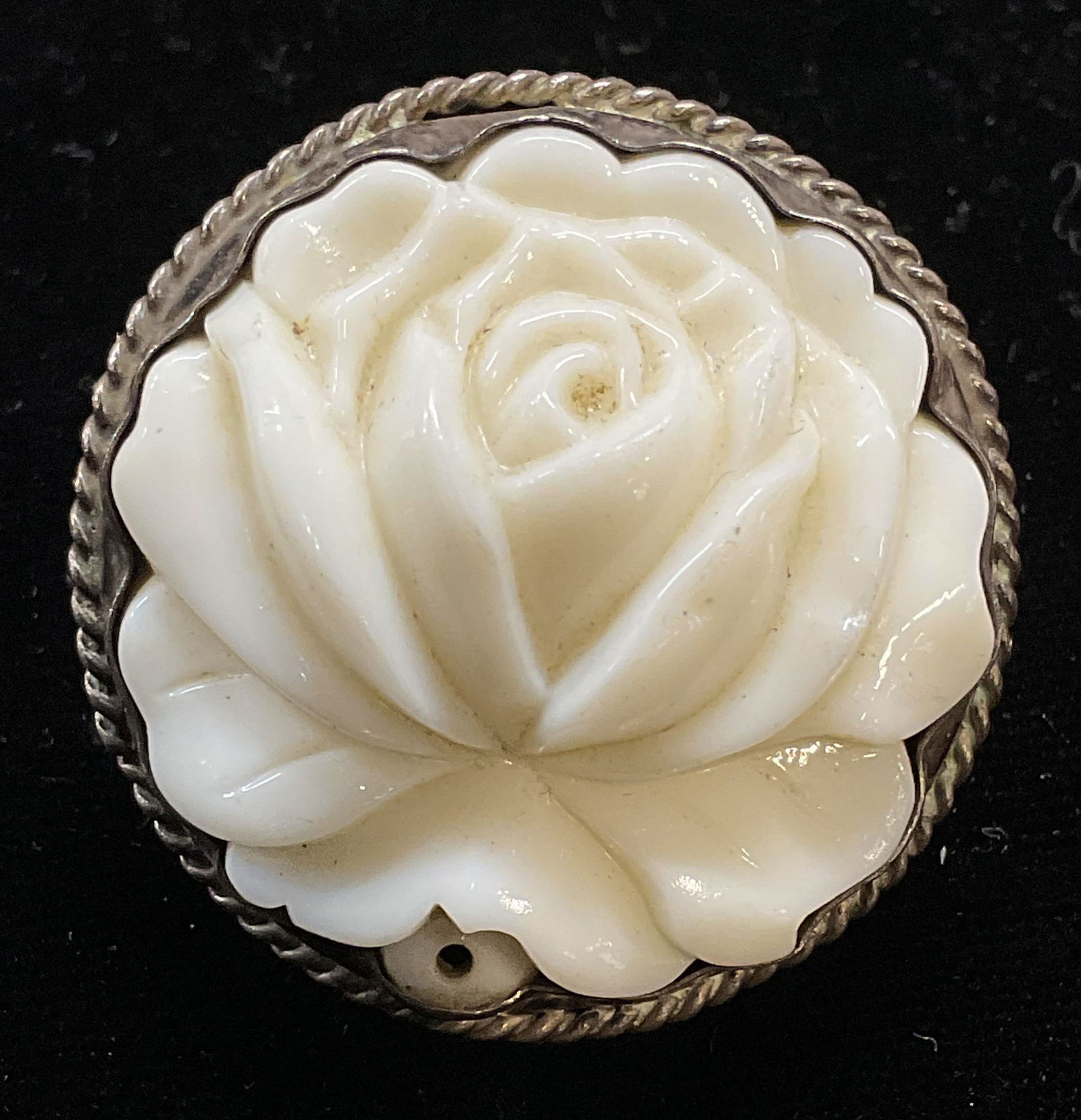 Sterling Silver White Flower Cocktail Ring: Sterling silver cocktail ring with raised white flower setting. Flower appears to be ceramic, possibly composite. Ring size 8.75. Total weight 18.3 grams. Some scratching. Tests for sterling using aci