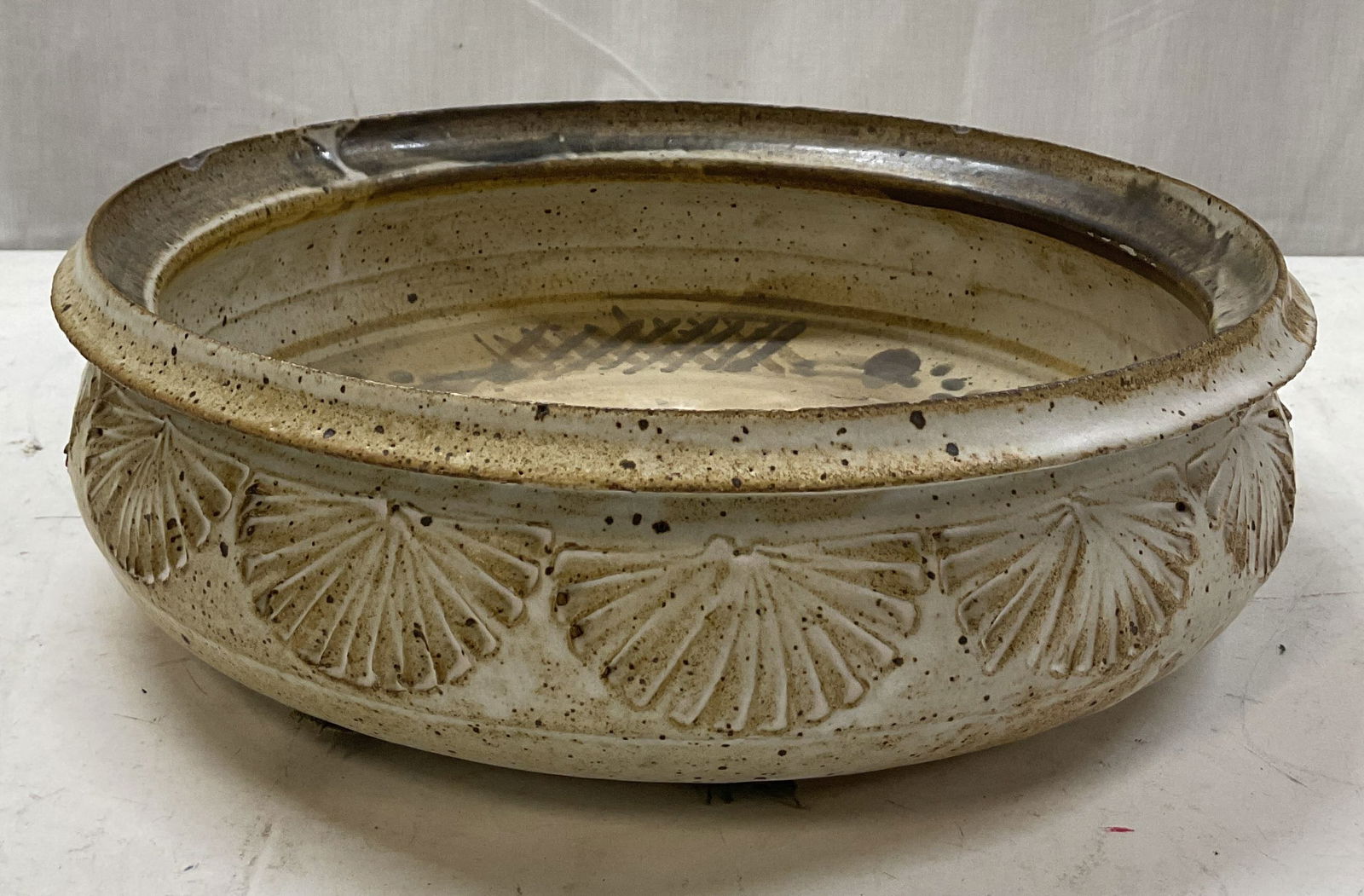 Vintage Handmade Studio Pottery Bowl: Vintage handmade studio pottery bowl. Stamped on underside. Abstract design on interior in brown and black. Wide rim. Carved fan like texture on exterior with a dark brown finish. Measures ht approx 4