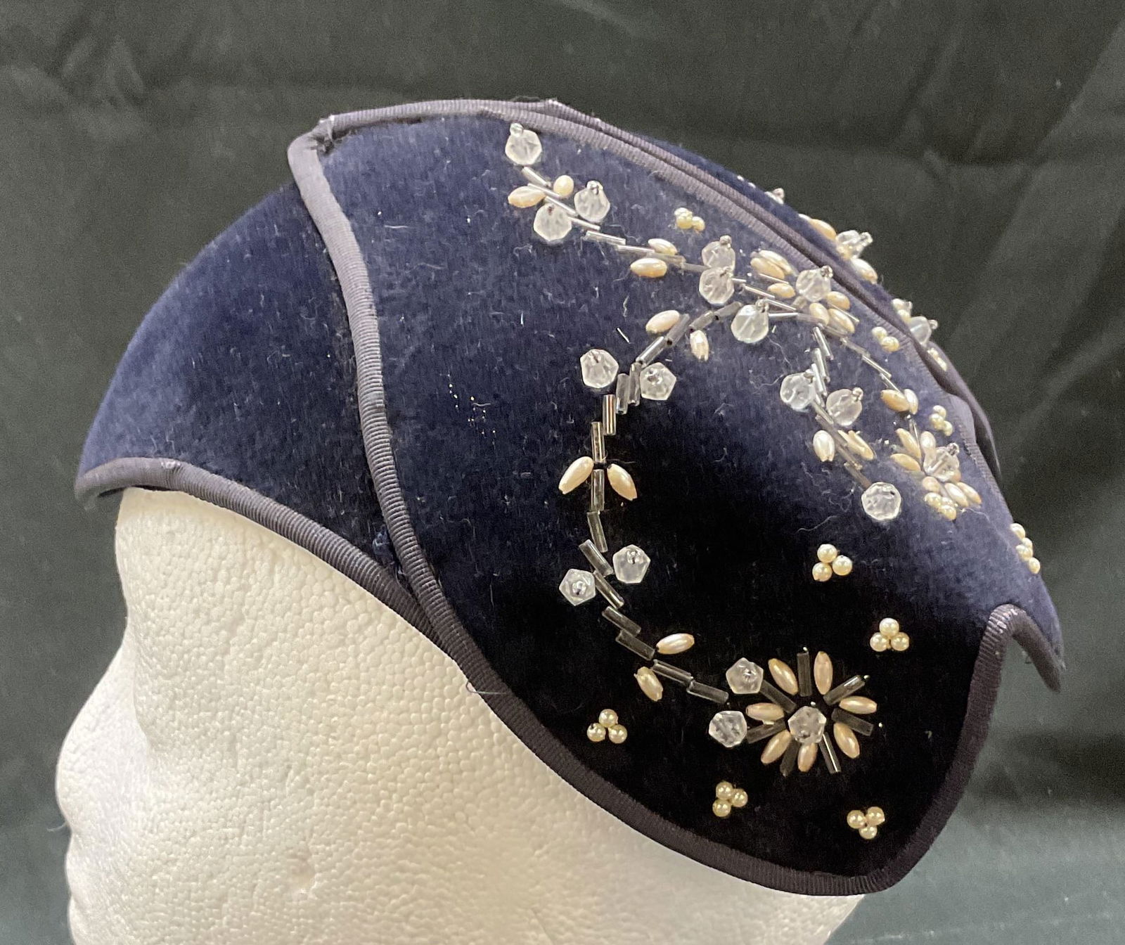 Flechats Blue Beaded Fascinator France: Flechats dark blue beaded fascinator. Made in France. Size 22. Feels like wool. Beaded floral design with silver tones. Wear consistent with exposure. Fascinator, hat, French beaded hat, Flechats fasc