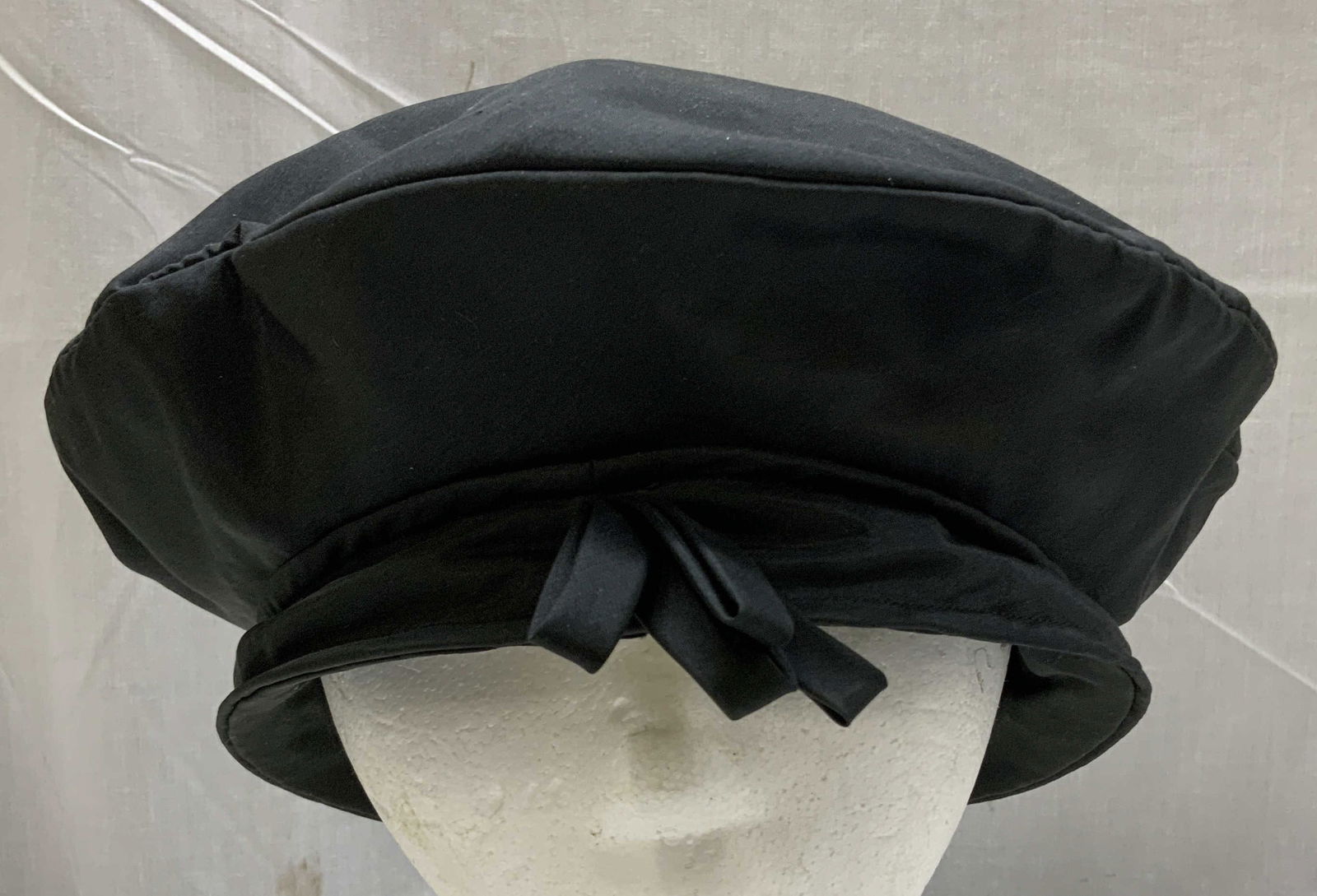 Mr. John De Prima Salon Black Beret Hat NY: Black beret hat w a small bow at the front. Appears to be possible satin material. Round shape. Signed & marked. Reads, Mr. John De Prima Salon. NEW YORK- MIAMI BEACH. Surface wear consistent to age,