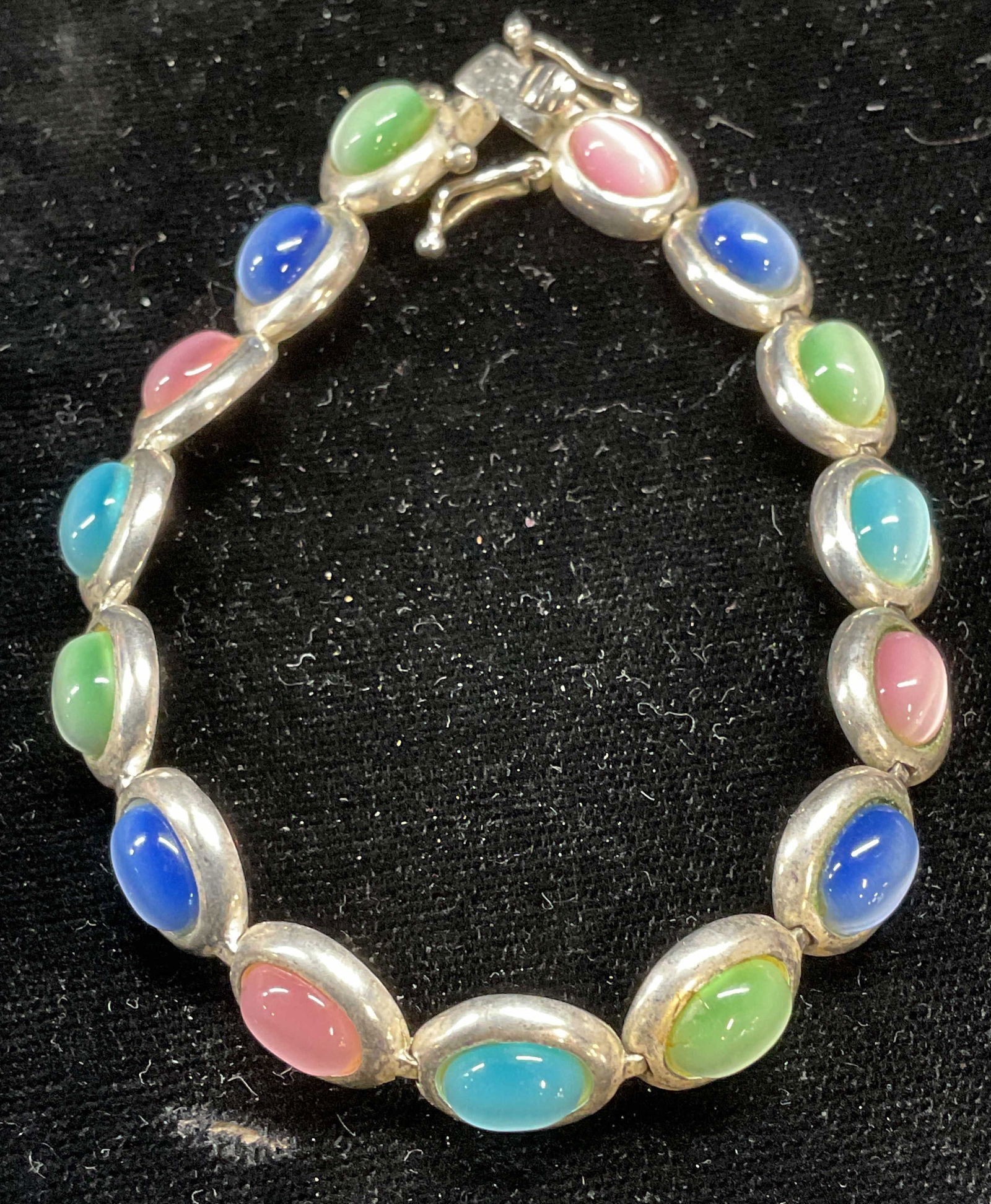 Signed PAS Sterling Silver Iridescent Bracelet: Signed PAS sterling silver bracelet with pastel multicolor iridescent glass cabochons. Marked sterling. Measures approx 7.25 inches long. Total weight 19.3 grams. Some scratching. Jewelry, fine jewelr