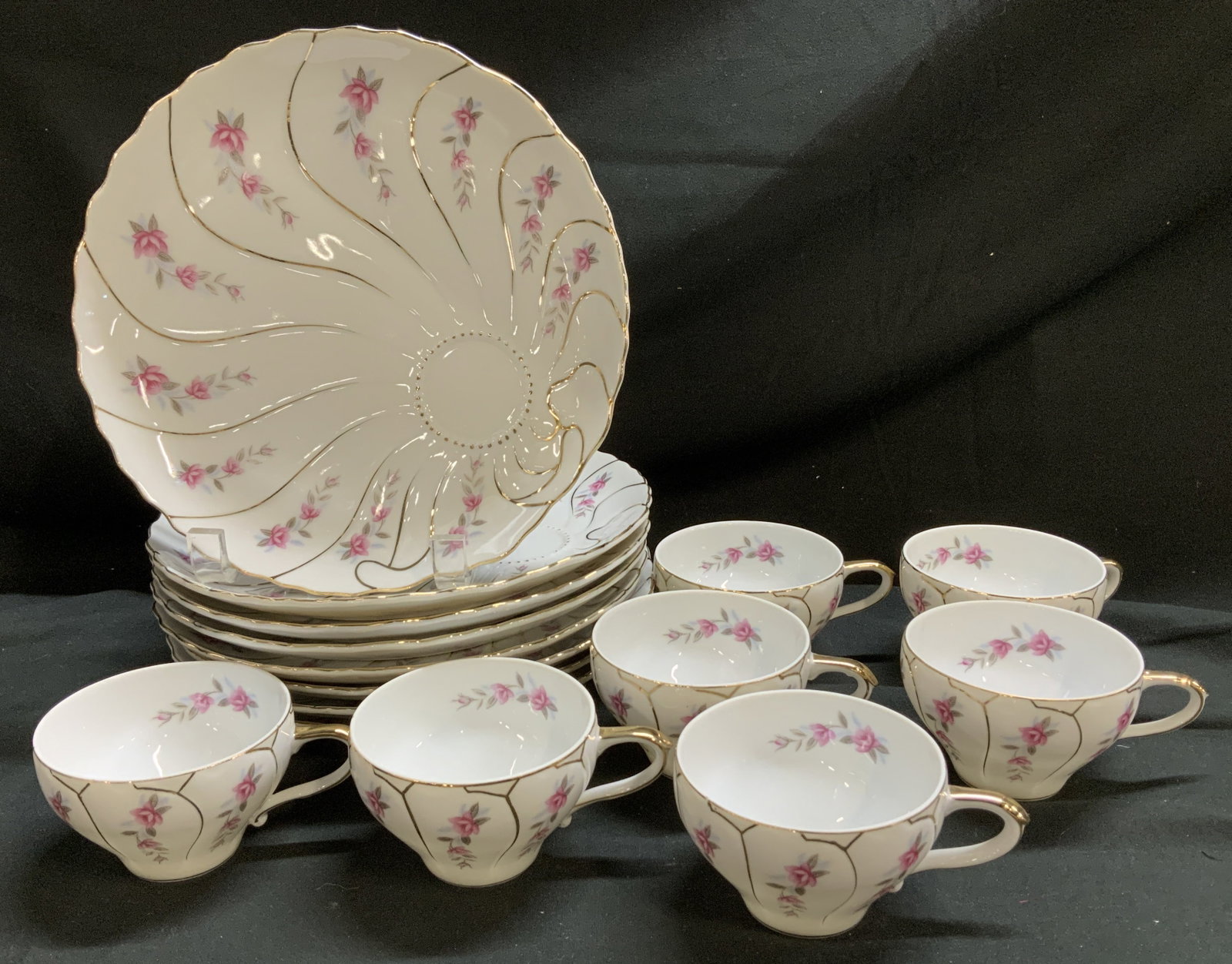 Set 16 Porc Pink Floral Snack Plate & Cups JAPAN: Lot includes, 8 snack plates & 8 cups. Plates feature round indentations for cups & scalloped edges. Pink floral detailing w gilt accents on rim. Signed & marked on underside. Reads, MADE IN JAPAN. Su