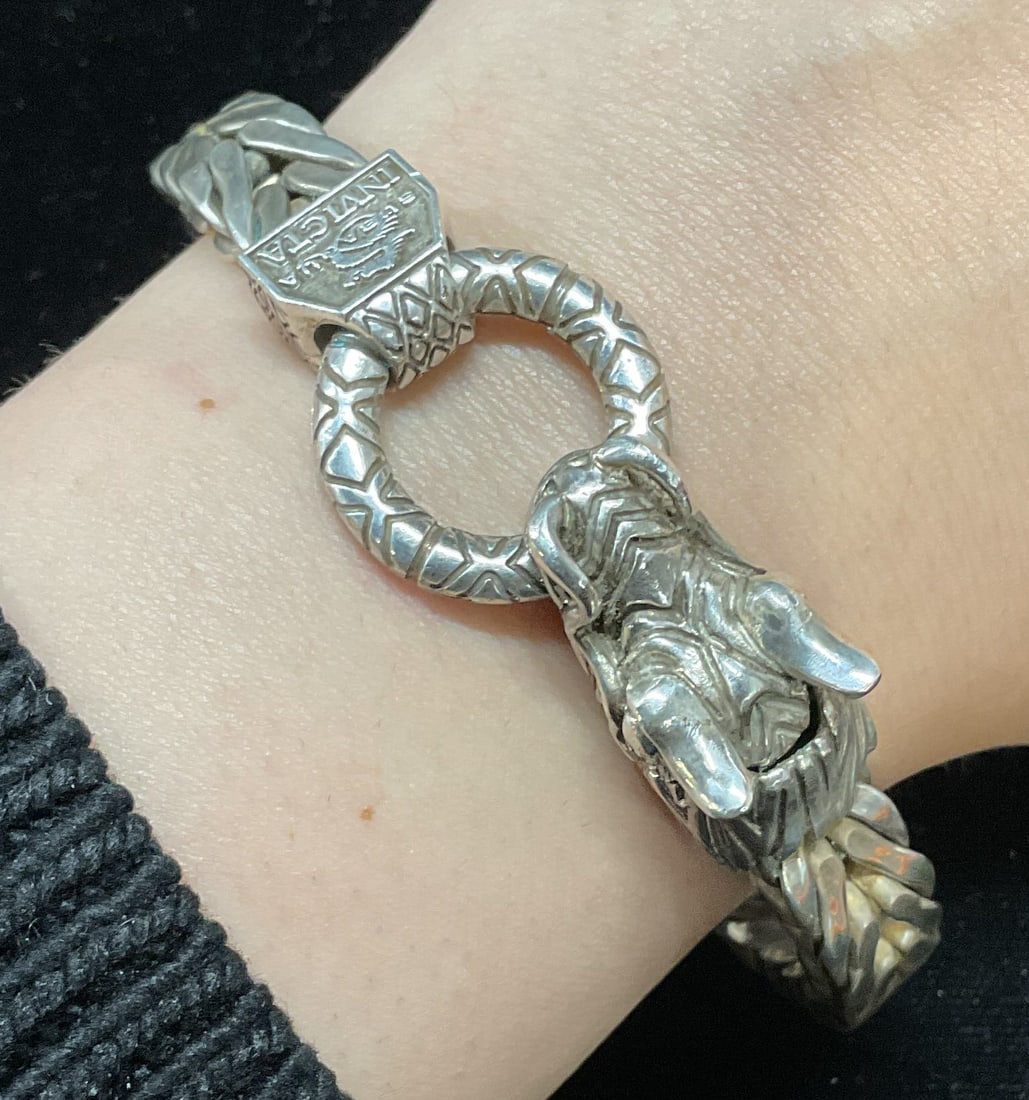 Invicta Sterling Silver Dragon Bracelet, Italy: Signed Invicta Sterling silver franco link chain bracelet with dragon head motif clasp. Marked sterling. Made in Italy. Measures approx 7.5 inches long. Total weight 2.01 ozt. Some scratching. Jewelry